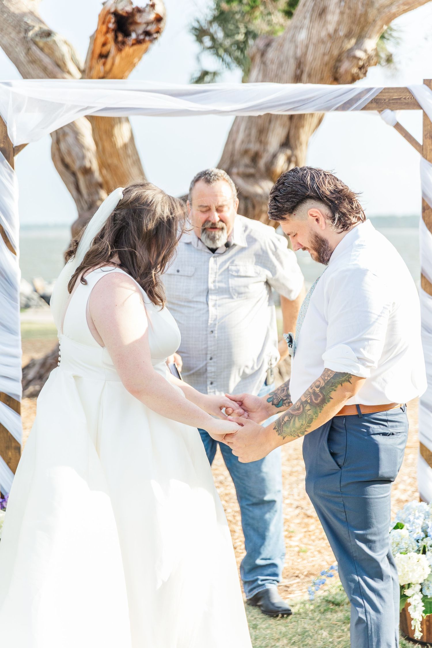 A romantic outdoor wedding sequence shows a couple kissing under rustic wooden beams and trees.