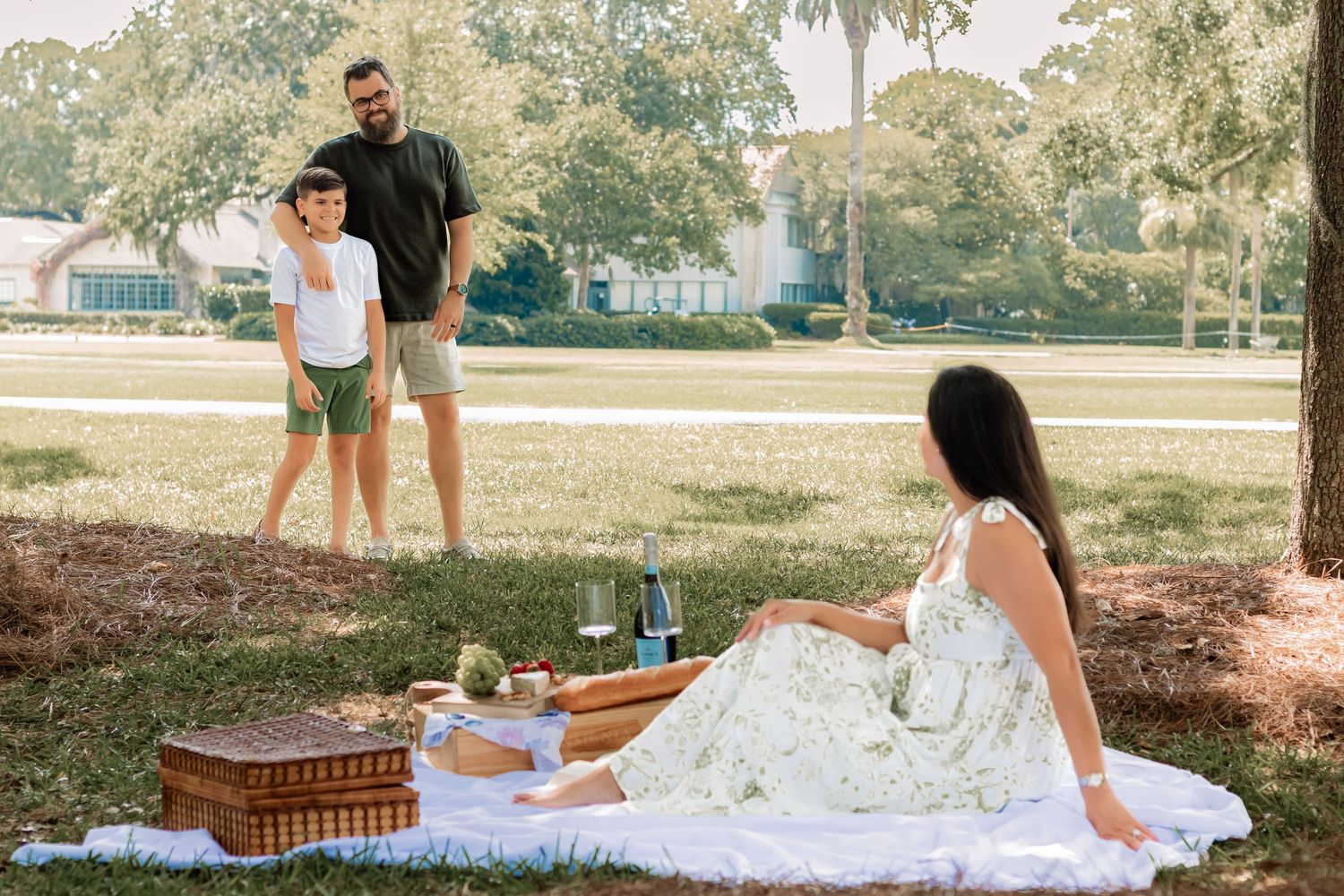 A sunny afternoon family picnic set beneath towering oak trees.