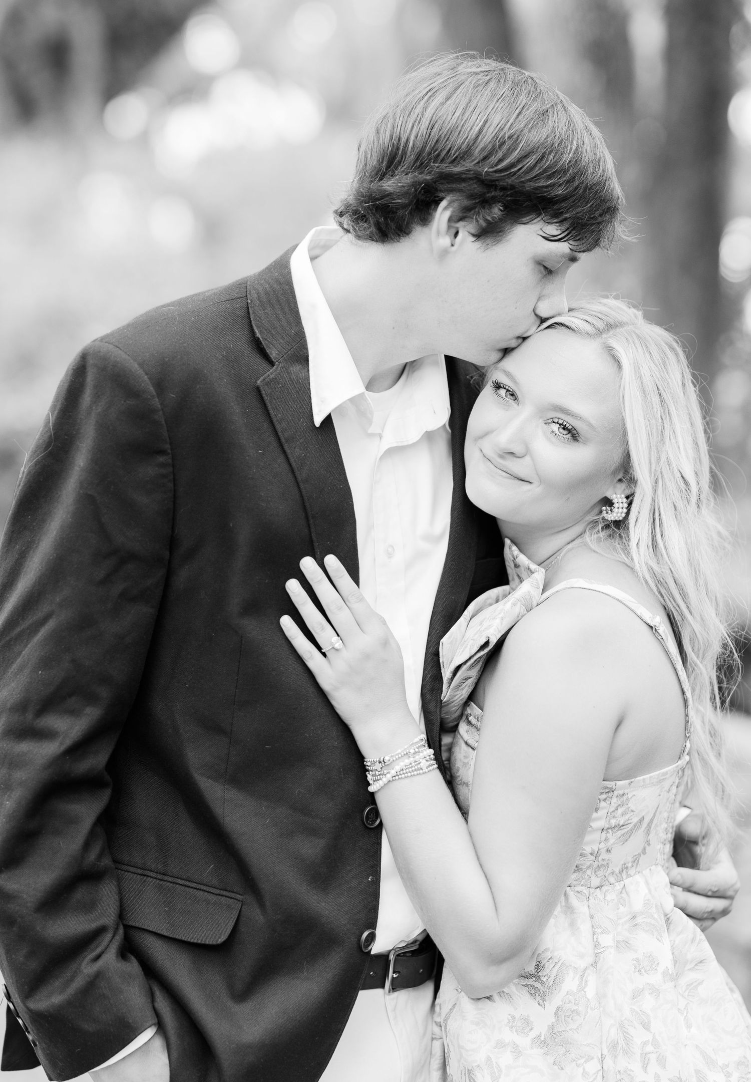 Black and white series showing tender moments between a couple in formal attire.