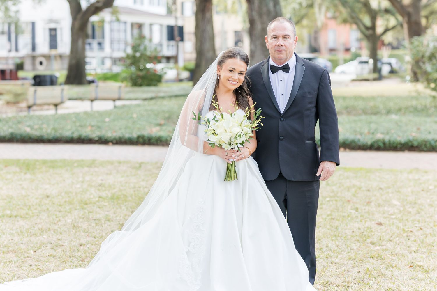 Wedding couple poses for romantic portraits in an outdoor garden setting.