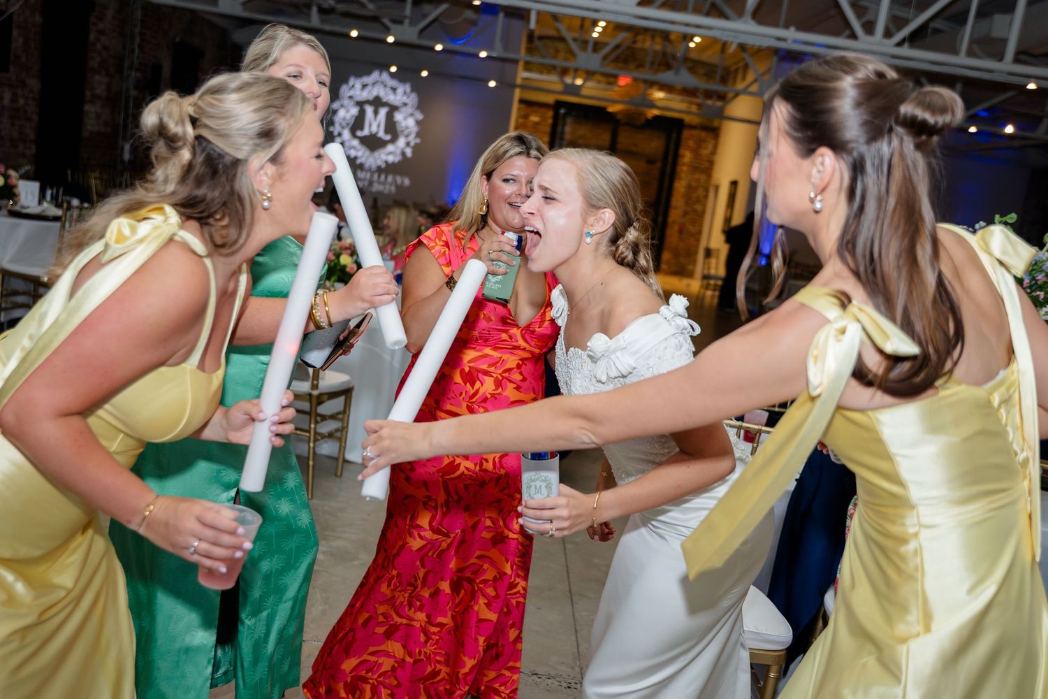 Collage of dance floor moments at a wedding reception with guests in colorful dresses celebrating together.