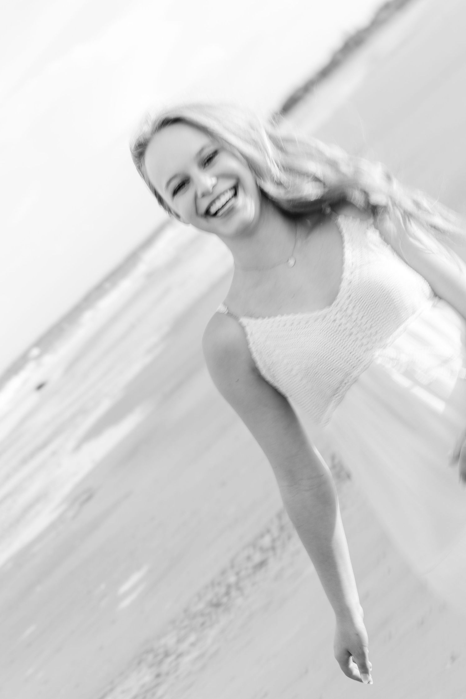 A series of black and white portraits showing joyful expressions in an artistic composition.