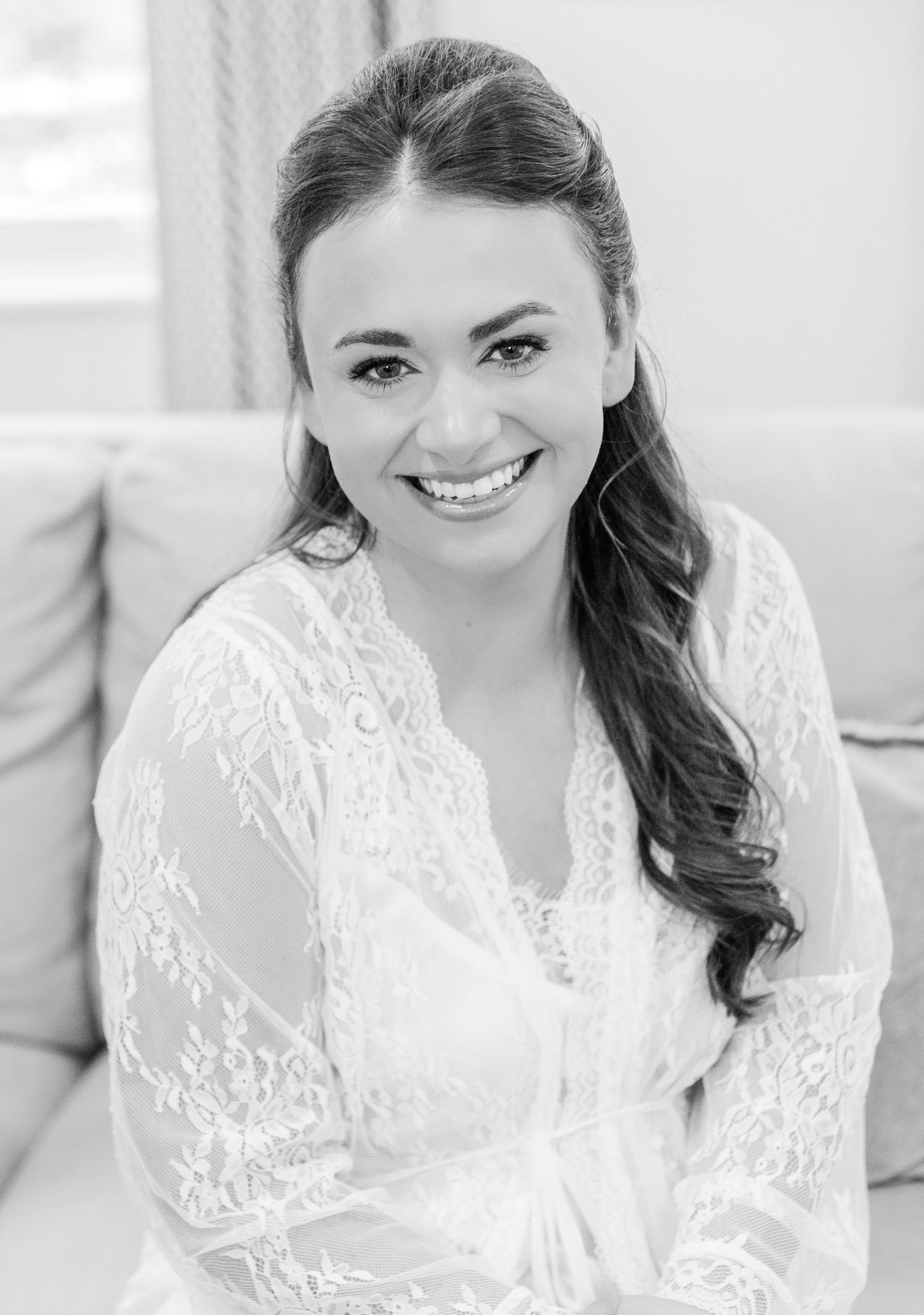 A series of black and white bridal portraits showing a woman in white lace smiling at different angles.
