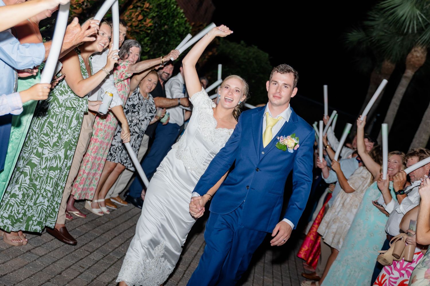 Wedding guests dancing and celebrating on the dance floor during a lively reception party.
