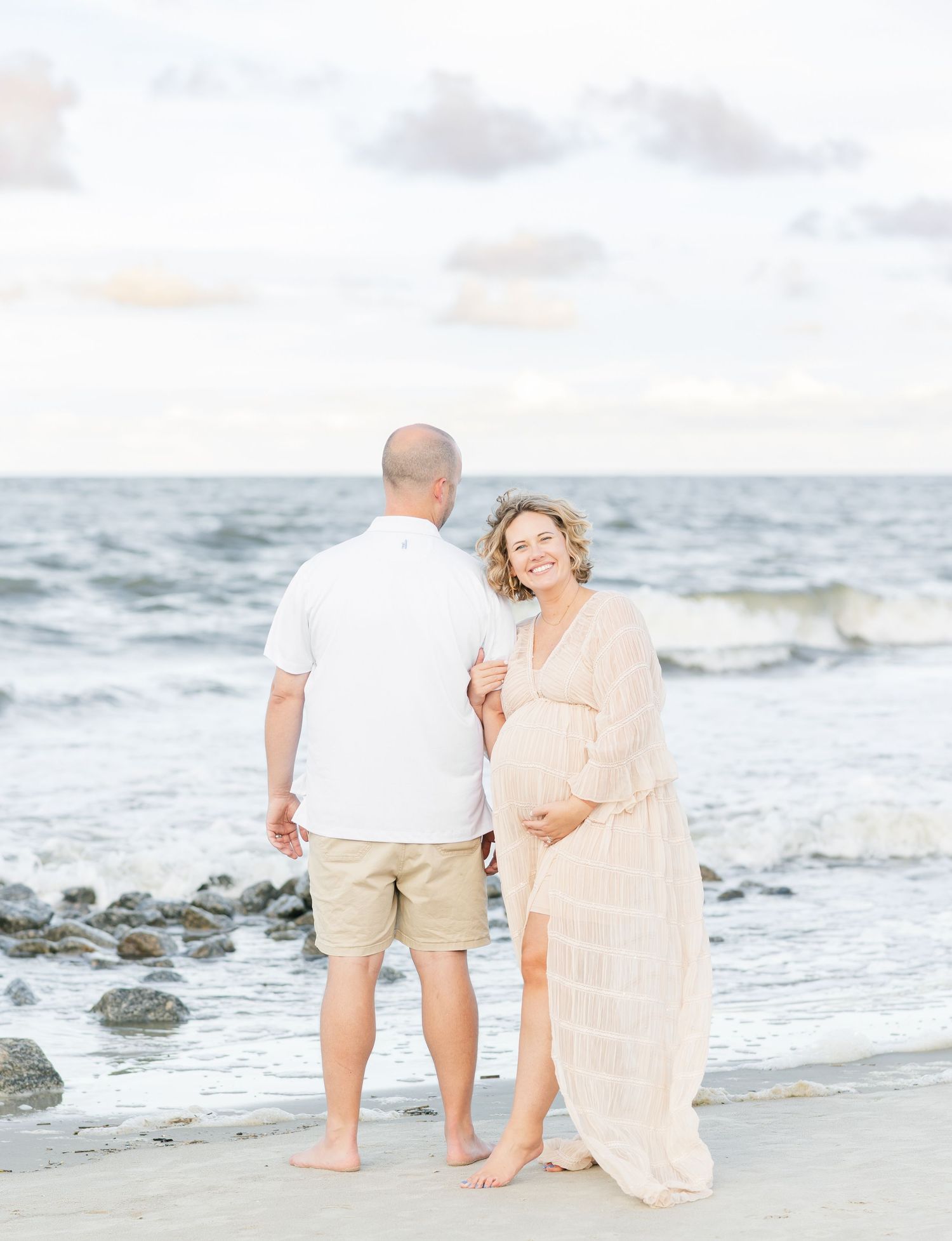 Dreamy beachside photography with waves and rocks creating a peaceful coastal scene.