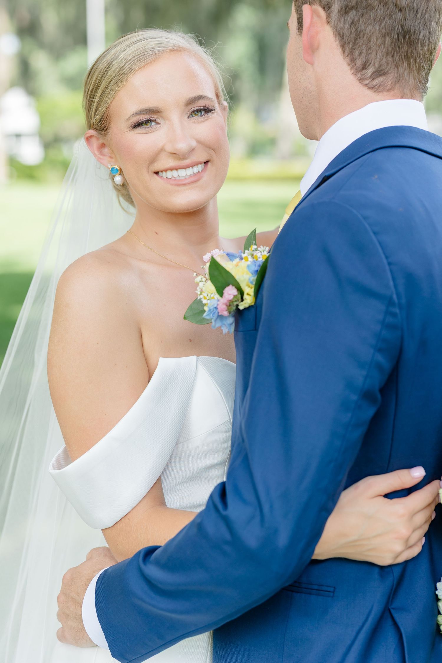 A series of wedding photos showing a bride in white and groom in navy blue suit embracing in an outdoor setting.
