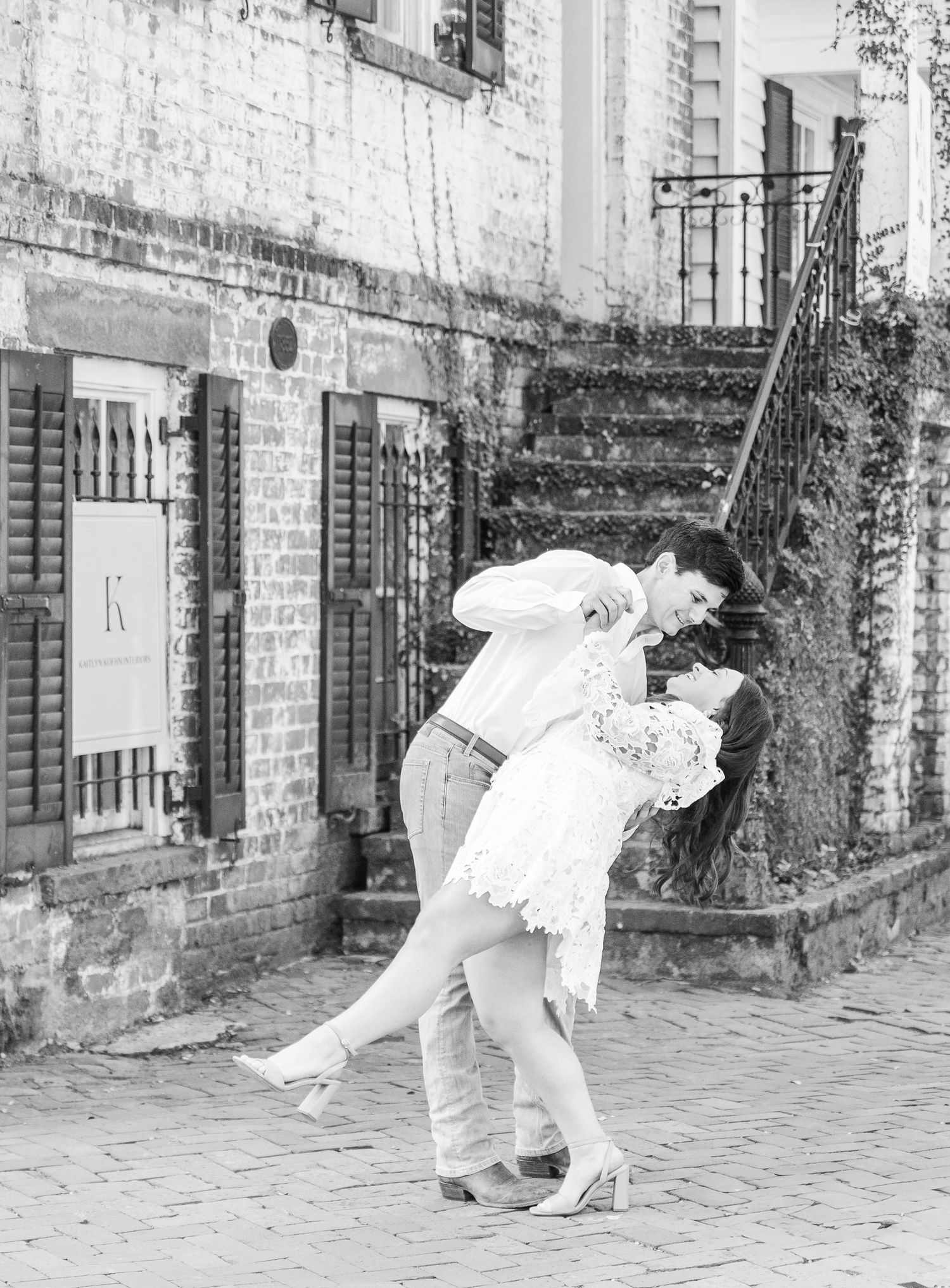 A romantic black and white photo showing a couple in an intimate dance pose.