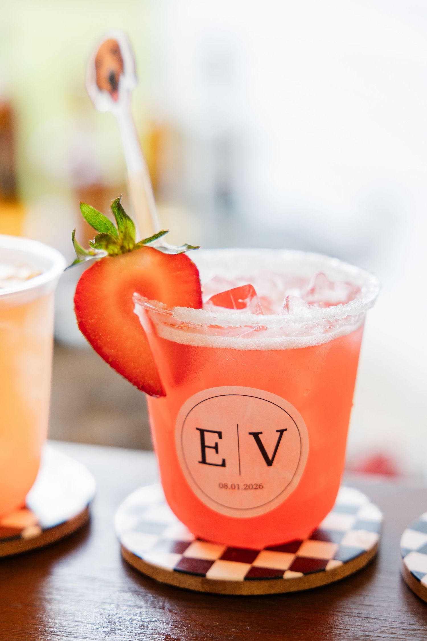 Strawberry margarita cocktail with salted rim and fresh strawberry garnish in a custom EV monogram wedding cup.