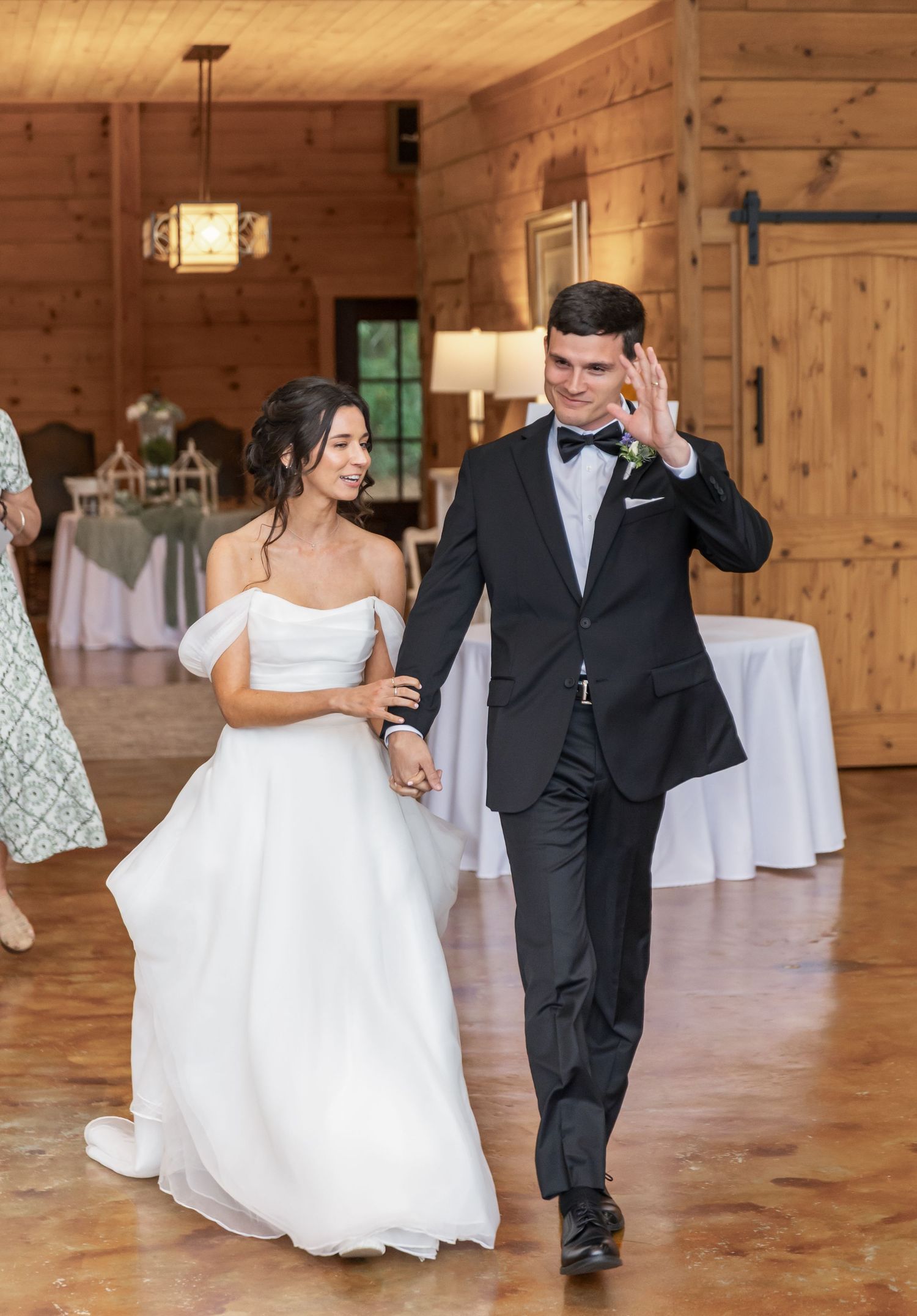 First dance sequence in rustic wooden reception venue with pine walls and floors.