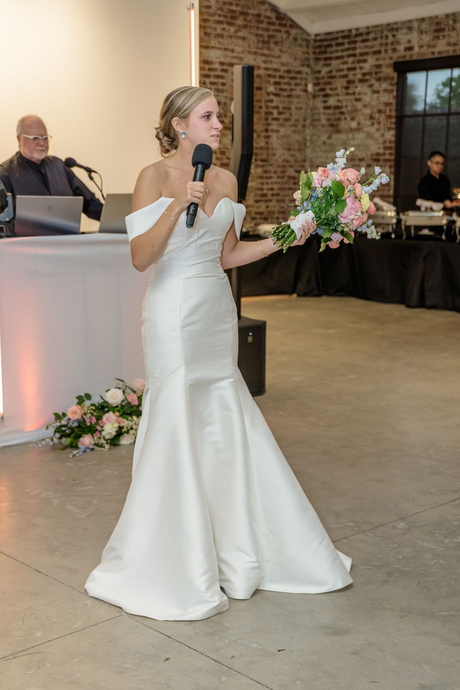 Wedding dance sequence in white gowns at an industrial-style venue with brick walls.