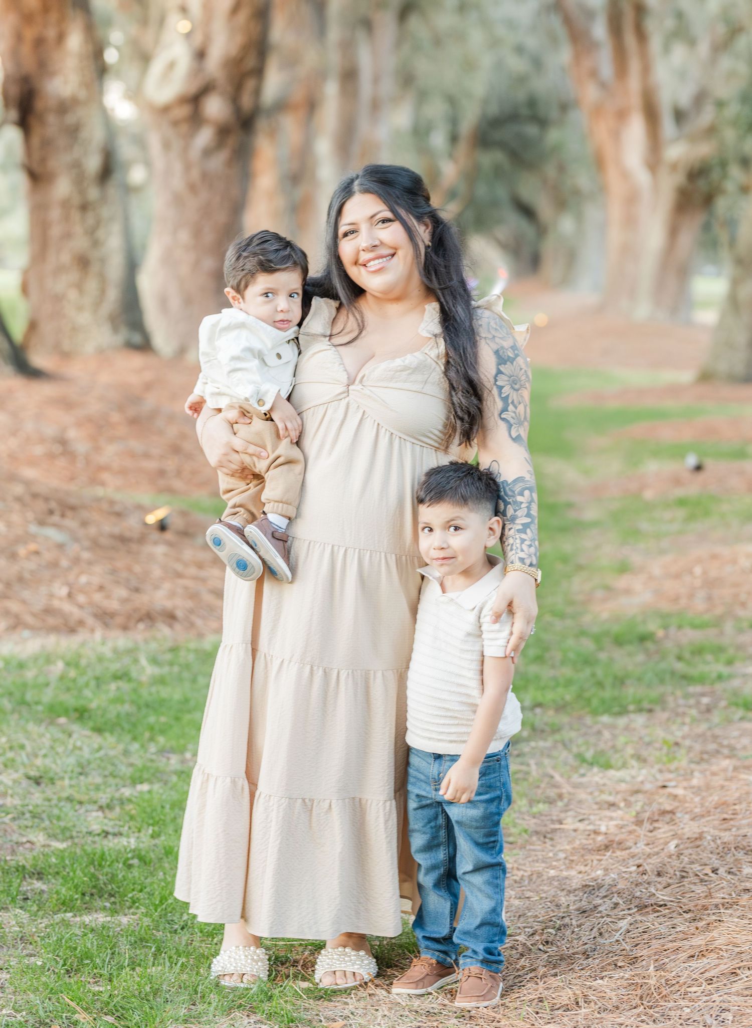 Sweet family portrait session captured in a wooded outdoor setting with natural lighting.