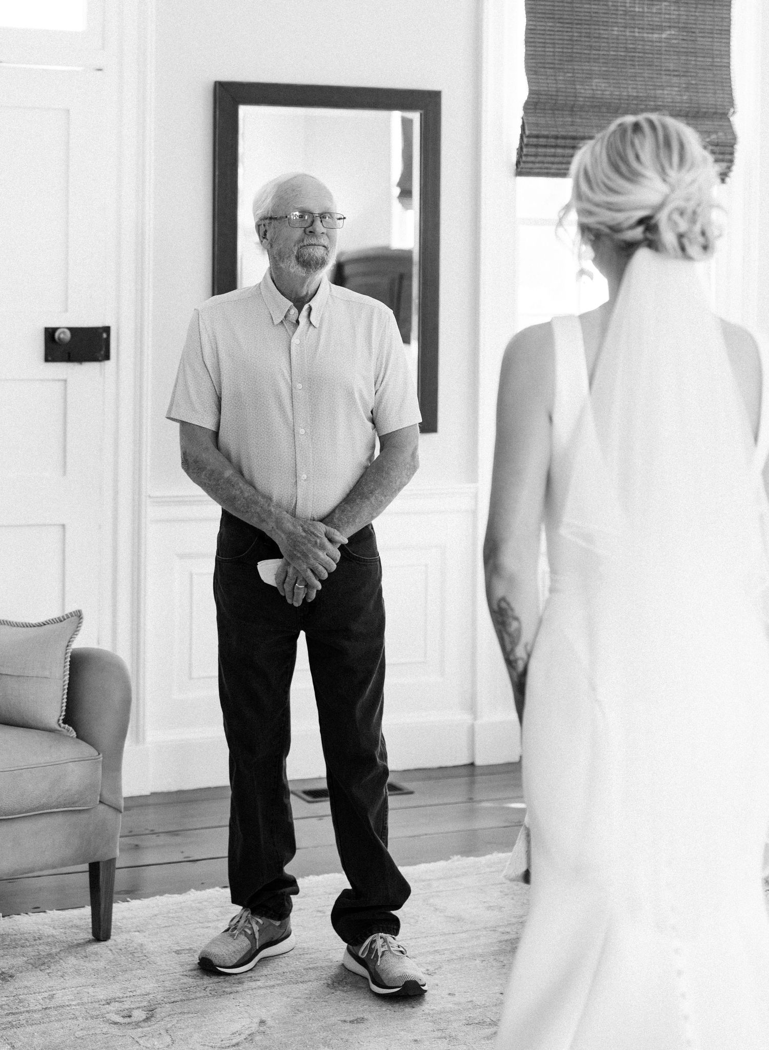Emotional black and white photo of father seeing bride in wedding dress for the first time.