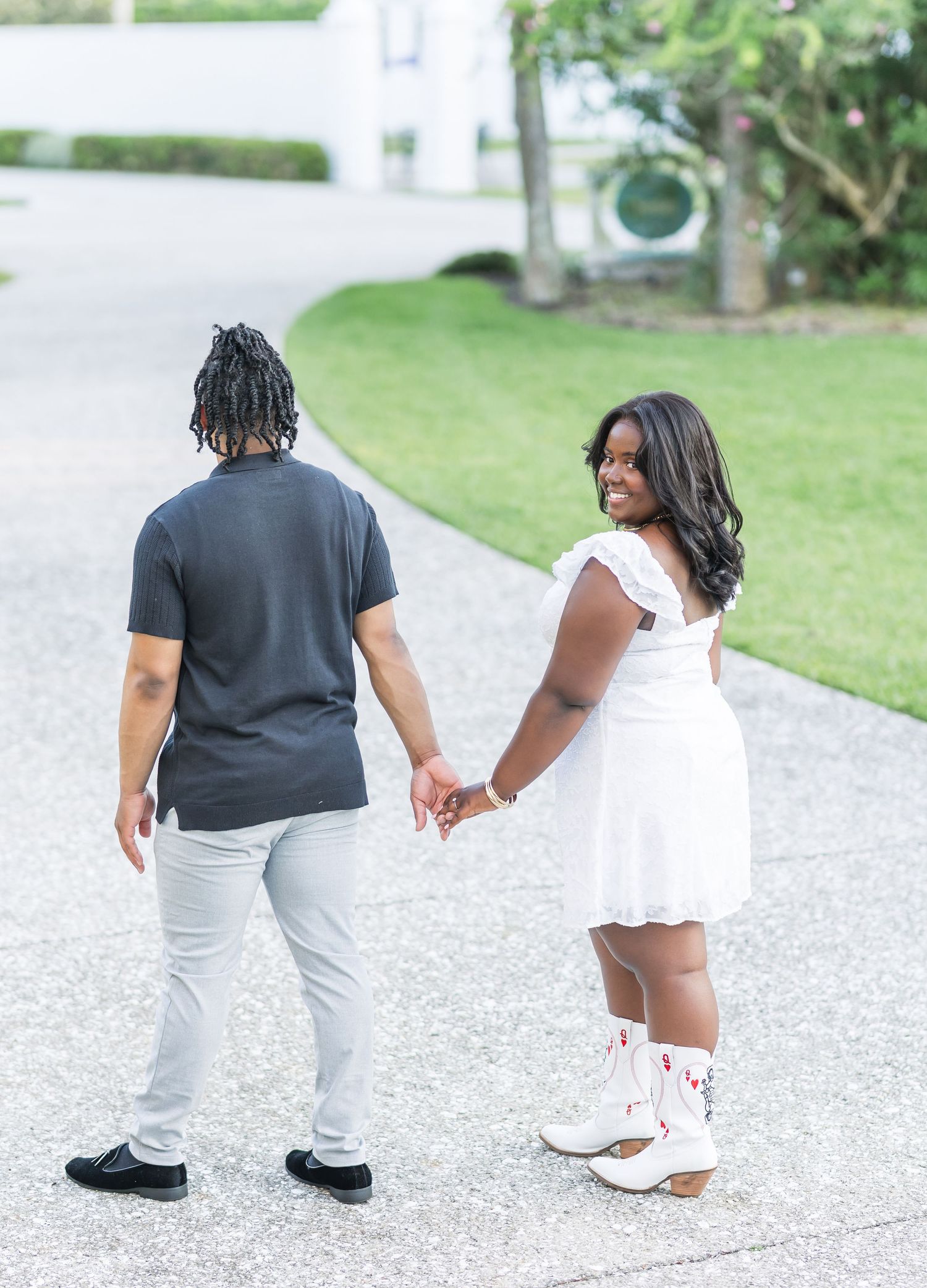Multiple views of people walking and holding hands on a gravel pathway near landscaped grounds.
