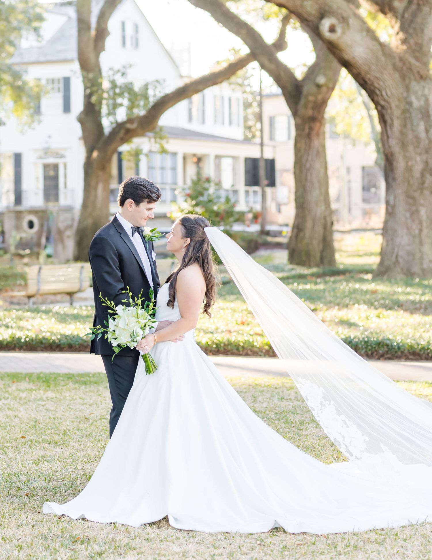 A bride and groom share romantic moments in a series of outdoor wedding photos under oak trees.
