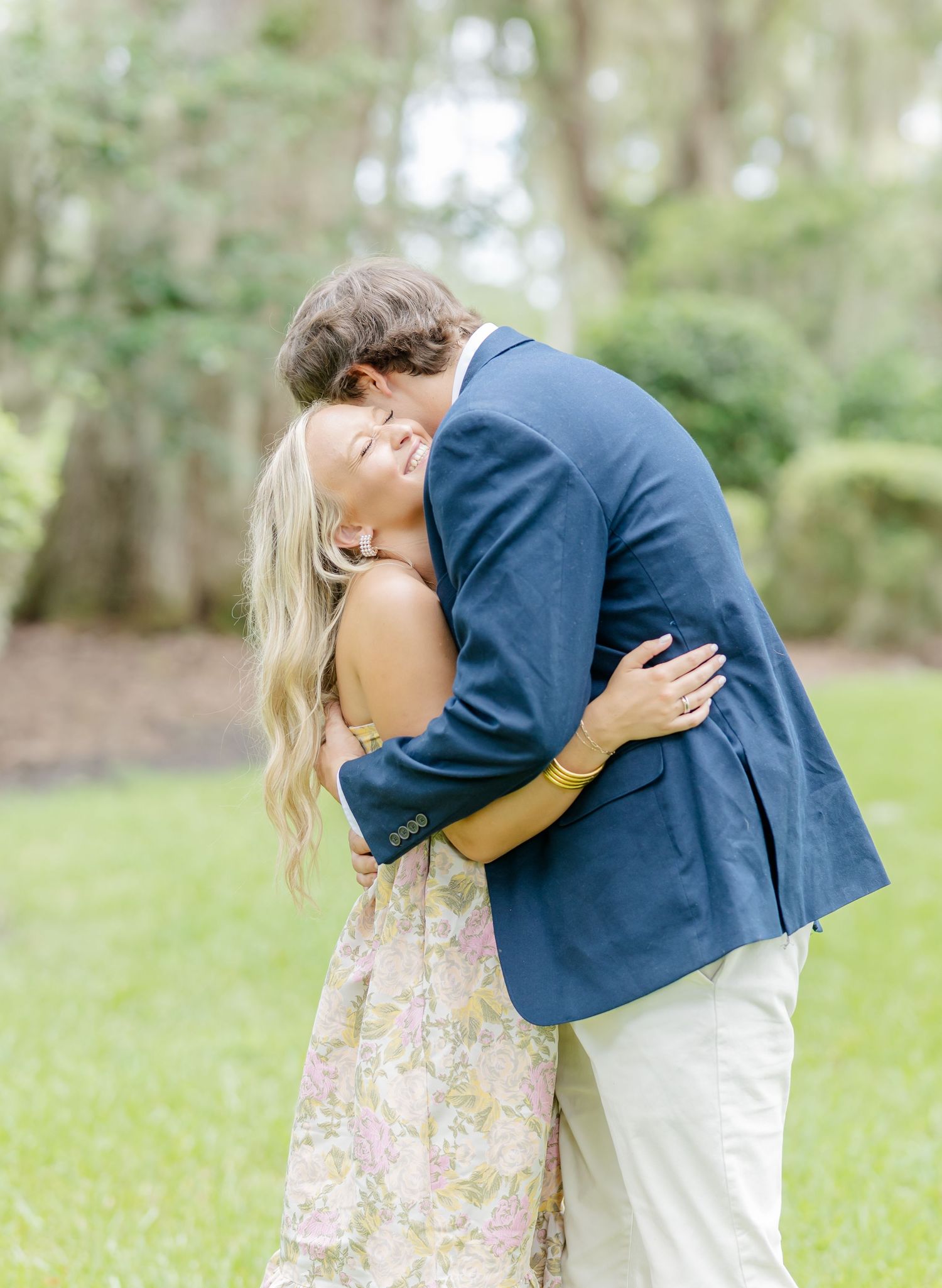 Romantic couple in a garden setting sharing tender embraces.