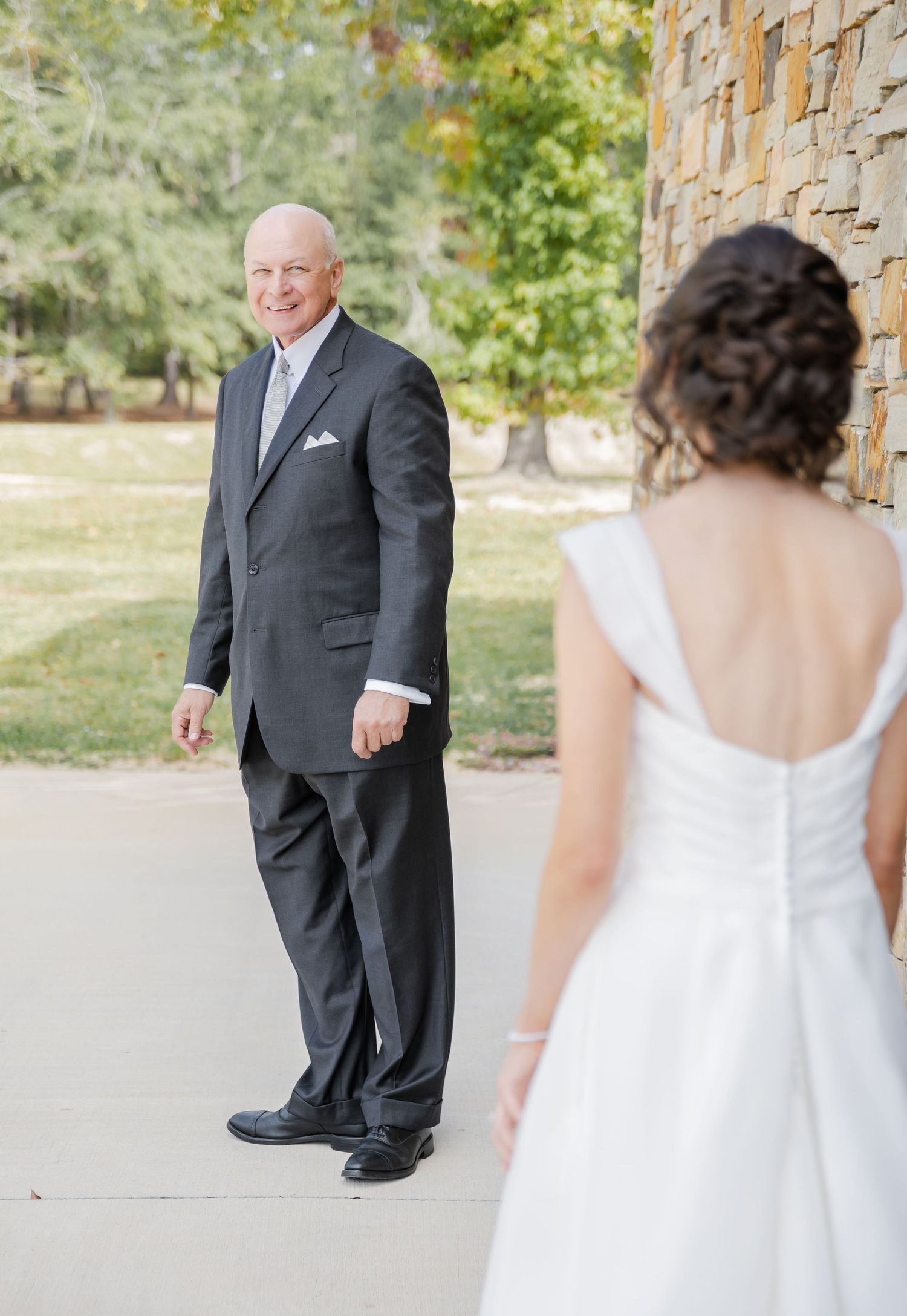 Wedding first look sequence showing emotional reactions between bride in white dress and groom in dark suit.