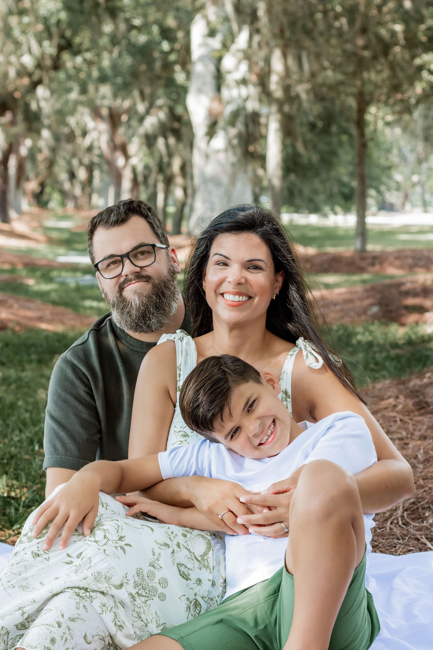 A happy family shares a tender moment together while relaxing outdoors.