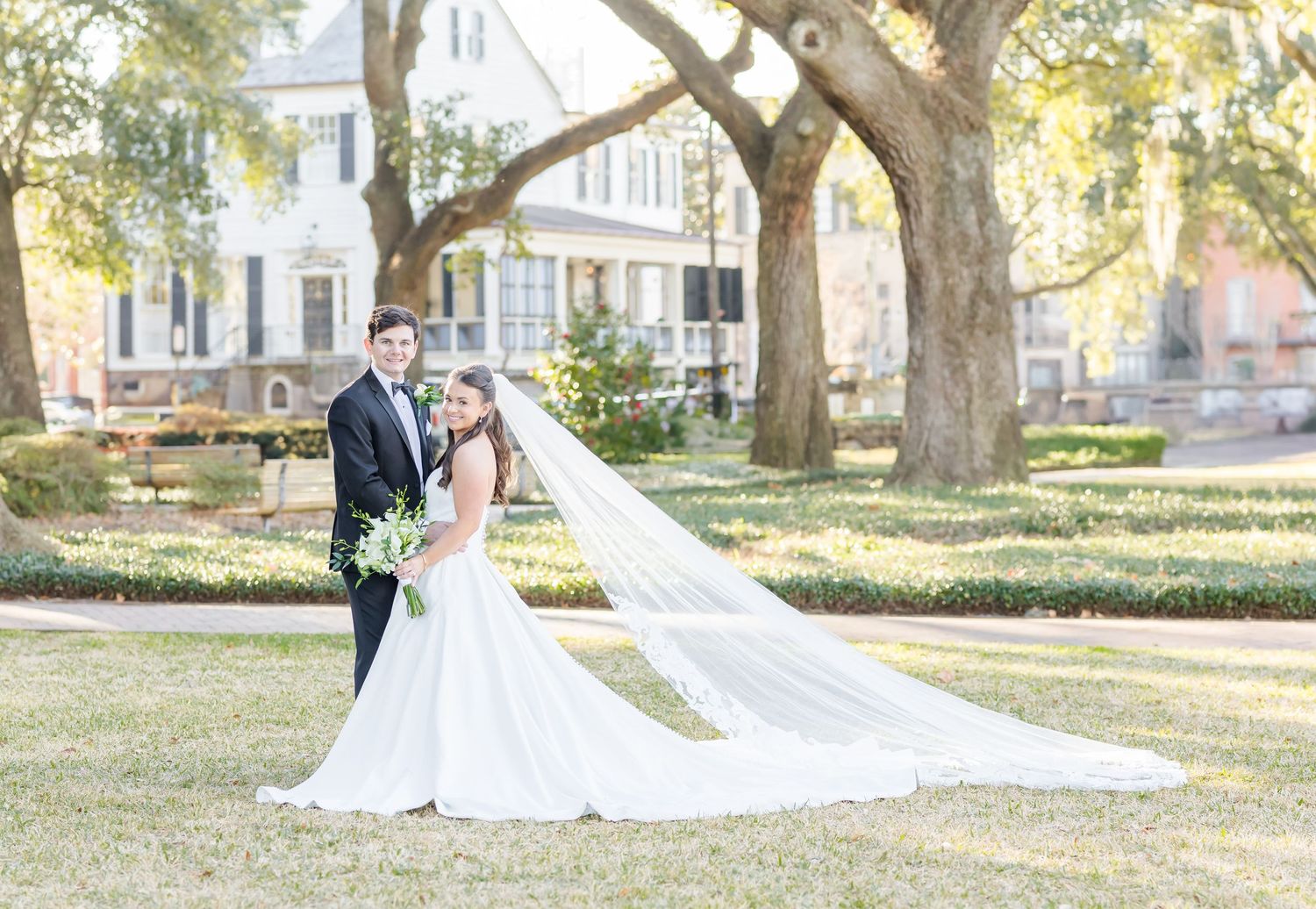 Romantic outdoor wedding photography session captured under sprawling oak trees.