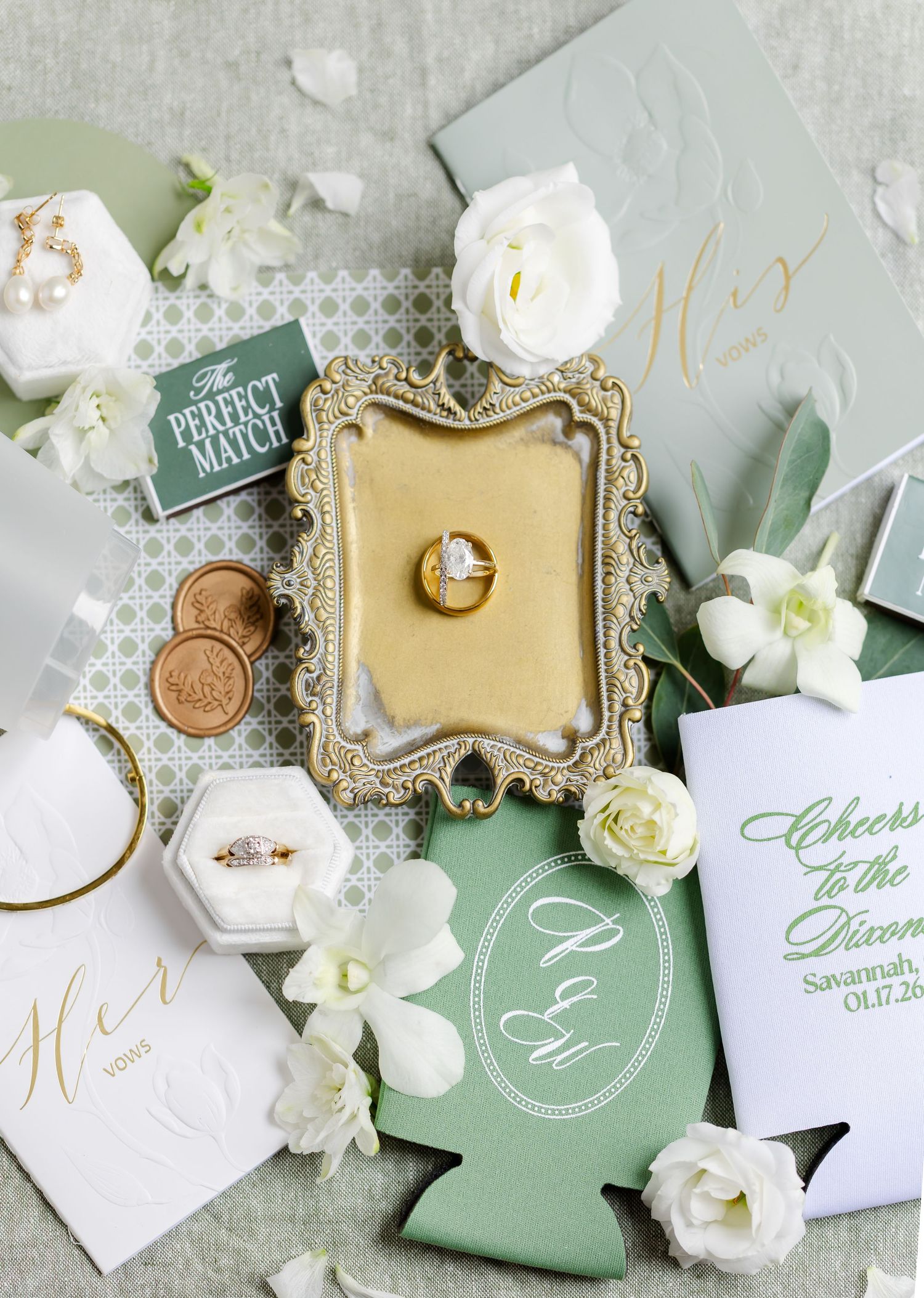 Elegant wedding stationery and decor in sage green and white with gold accents and delicate orchids.