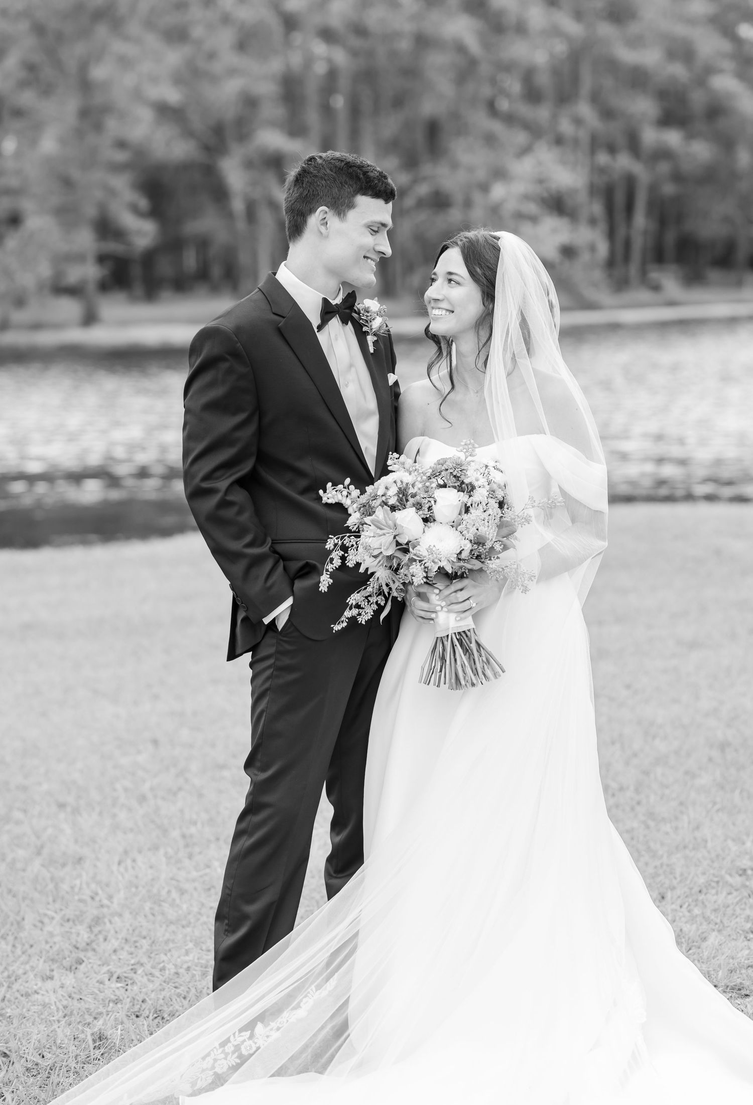 Black and white wedding portraits captured in a scenic outdoor setting.