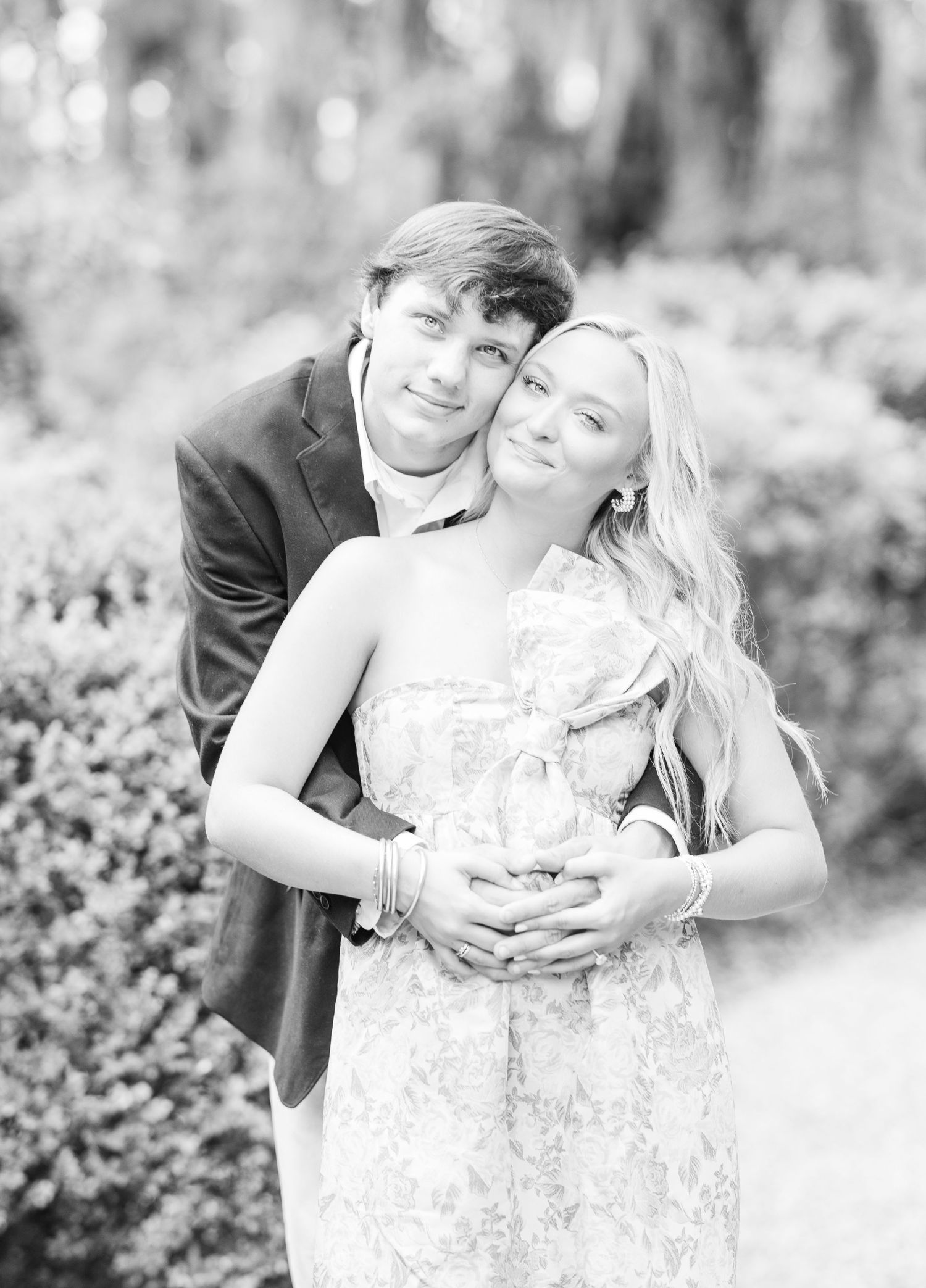 Black and white series capturing intimate moments between a couple in an outdoor setting.