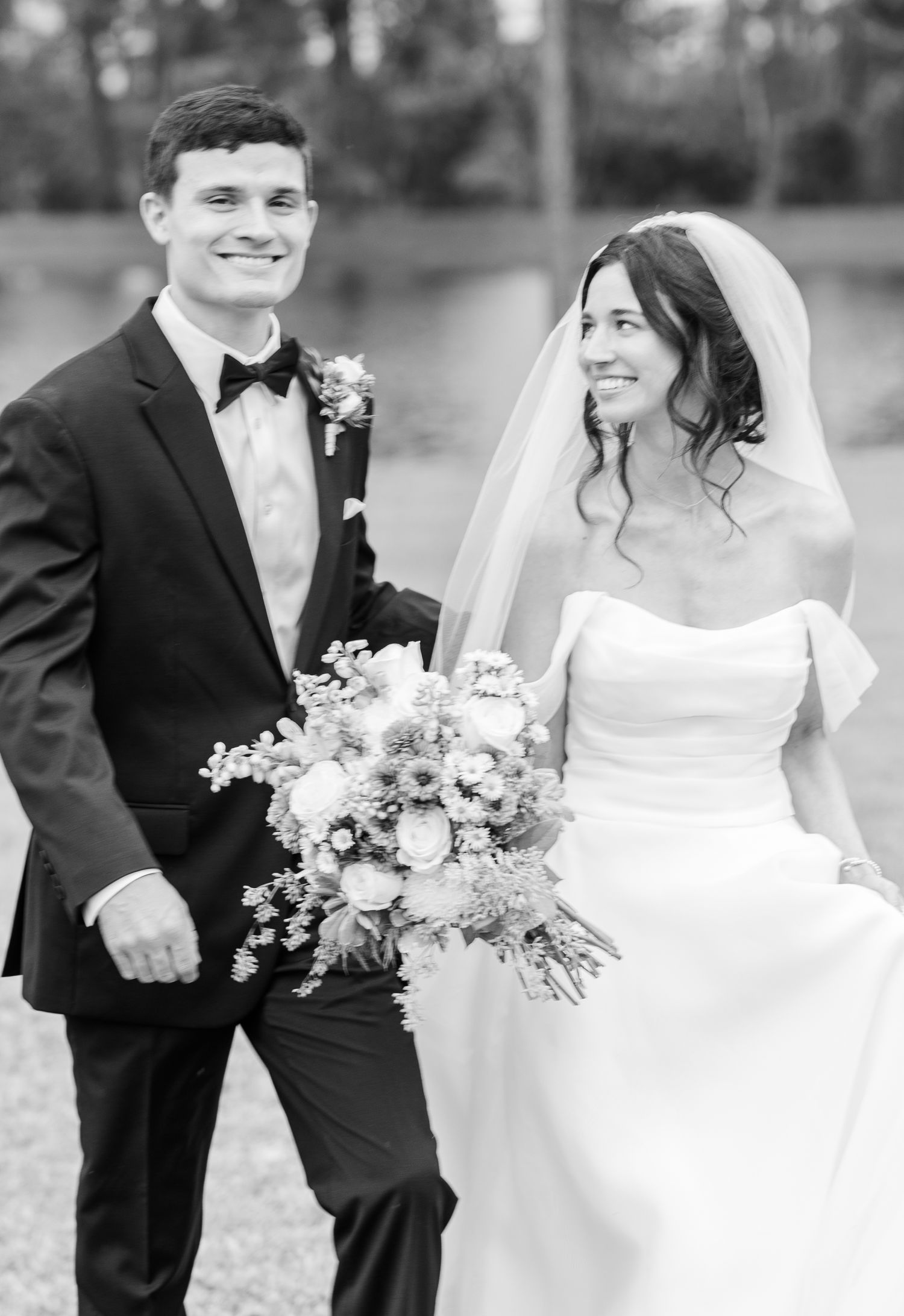 Black and white wedding portrait series showing a couple in formal attire with elegant floral bouquets.