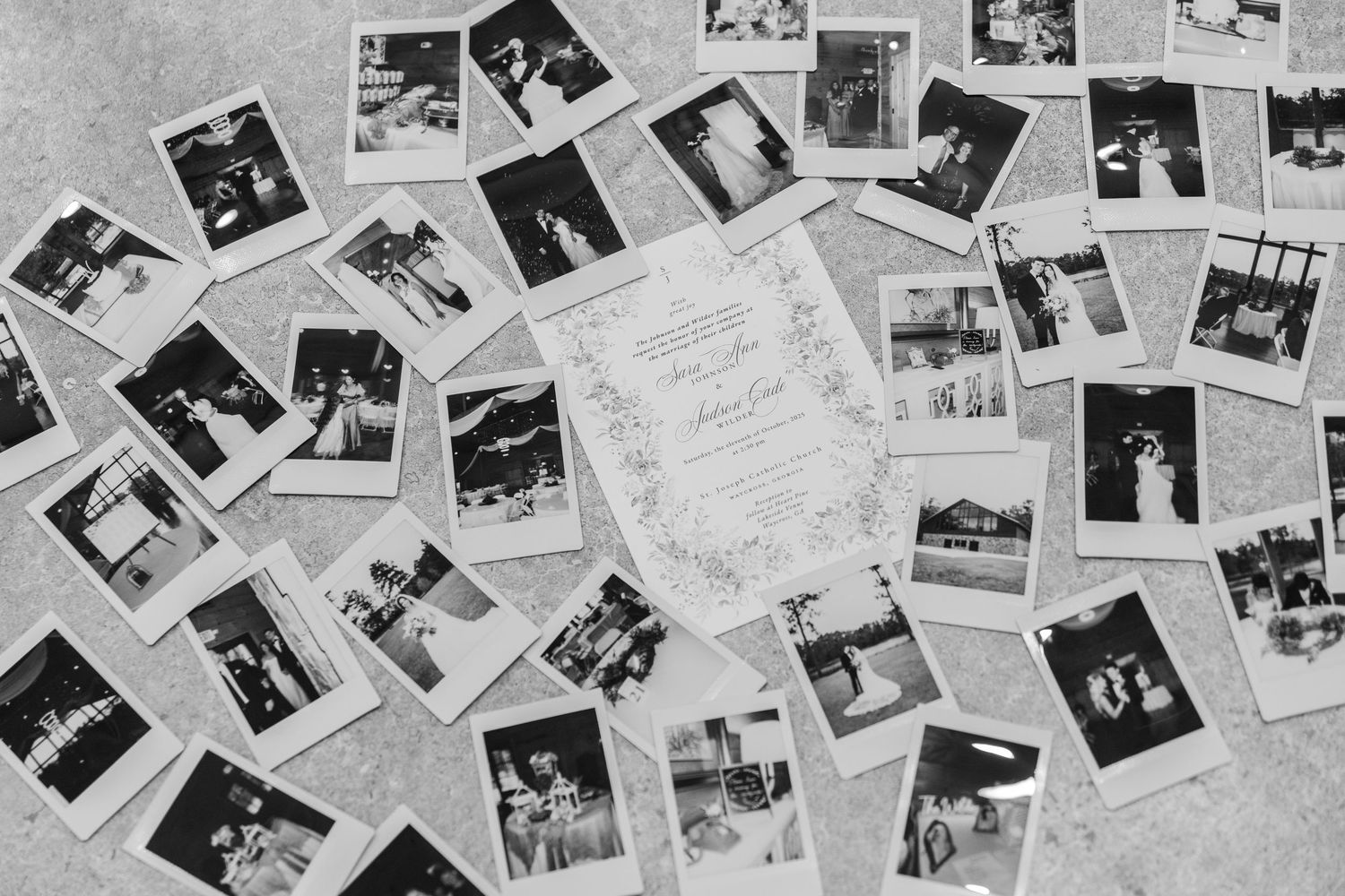 A collection of black and white vintage photographs scattered across a light surface creating a nostalgic collage.
