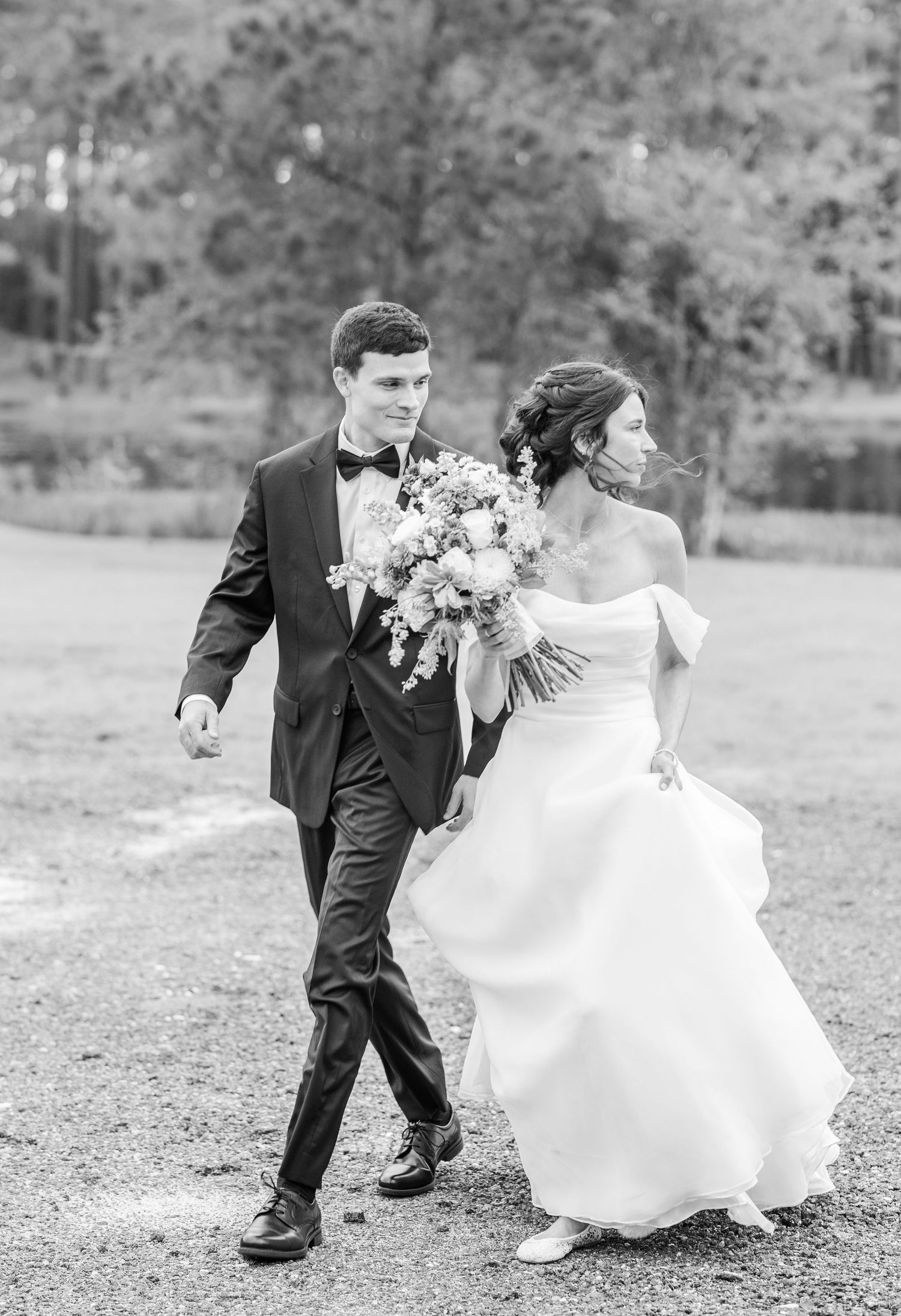 Black and white photos of couple walking together in wedding attire.