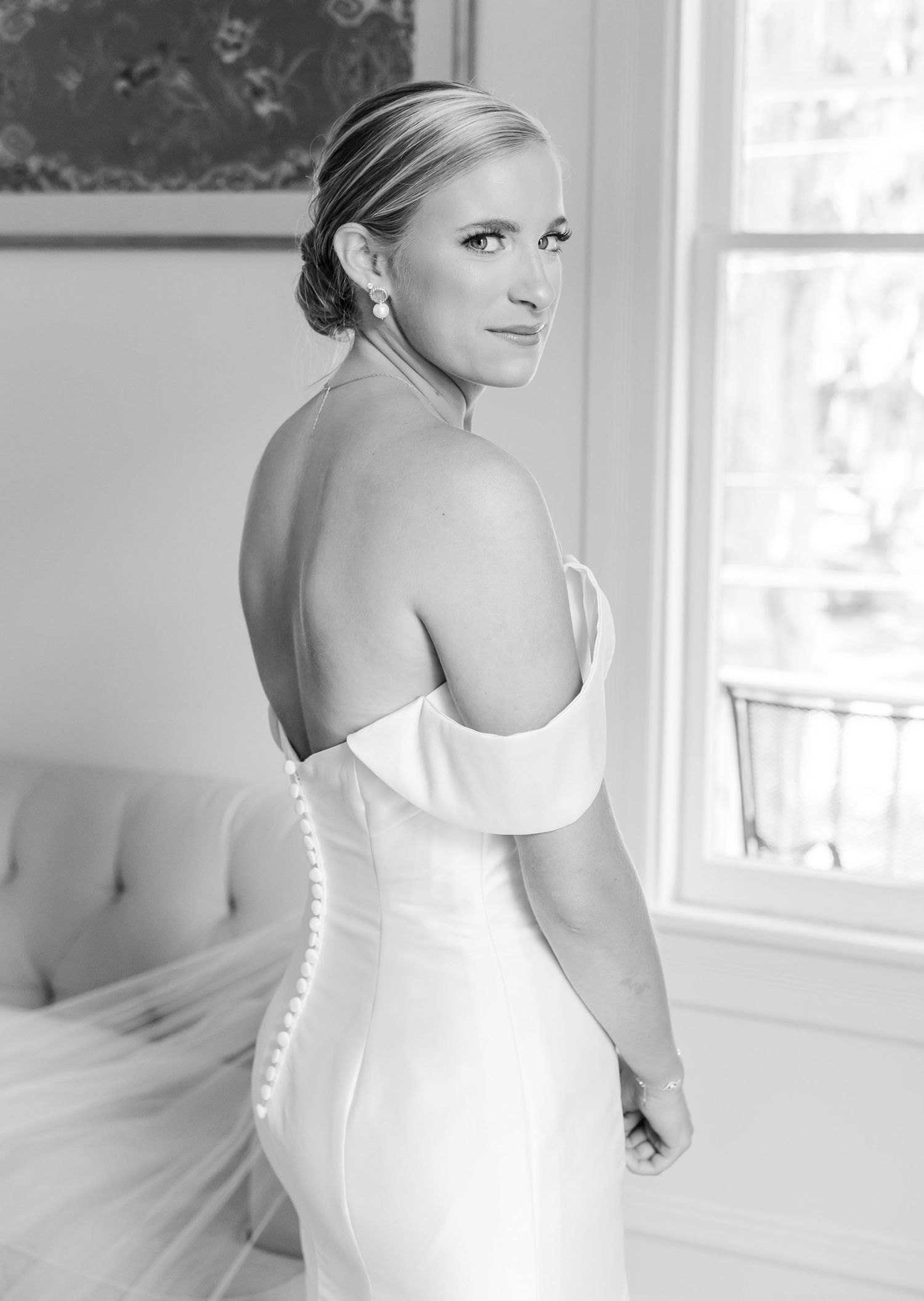 Black and white bridal portraits showing elegant poses against windows in a light-filled room.