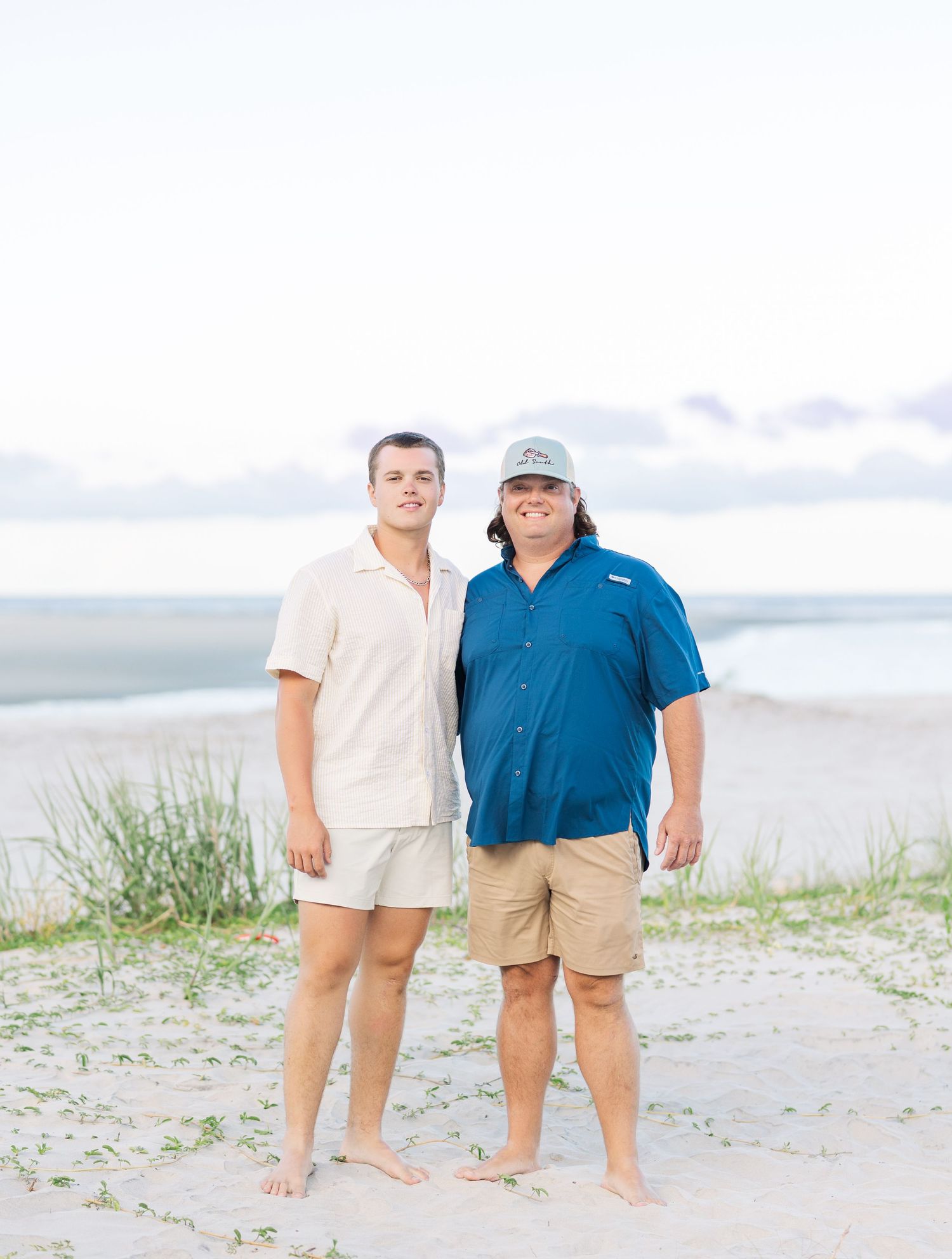 Beach photoshoot with people wearing coordinated casual summer outfits.