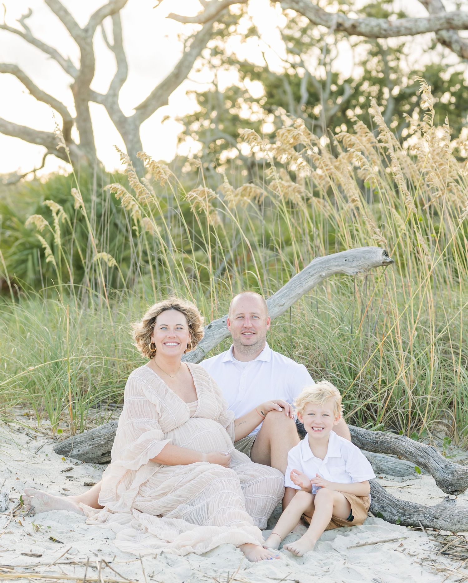 Relaxed family beach photography session with coastal grasses and driftwood.