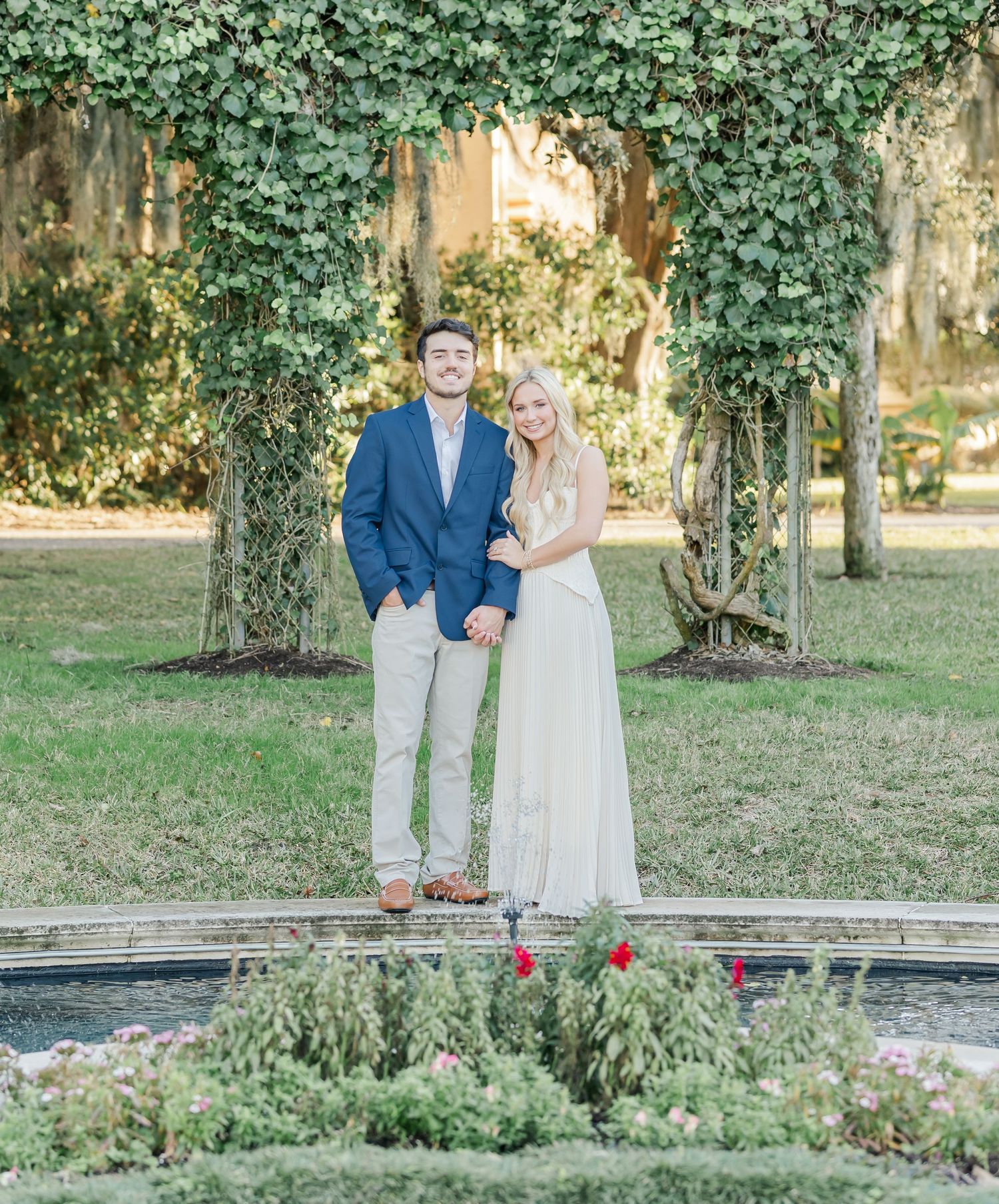Romantic garden setting with lush greenery and ivy-covered trees creating a natural outdoor backdrop.