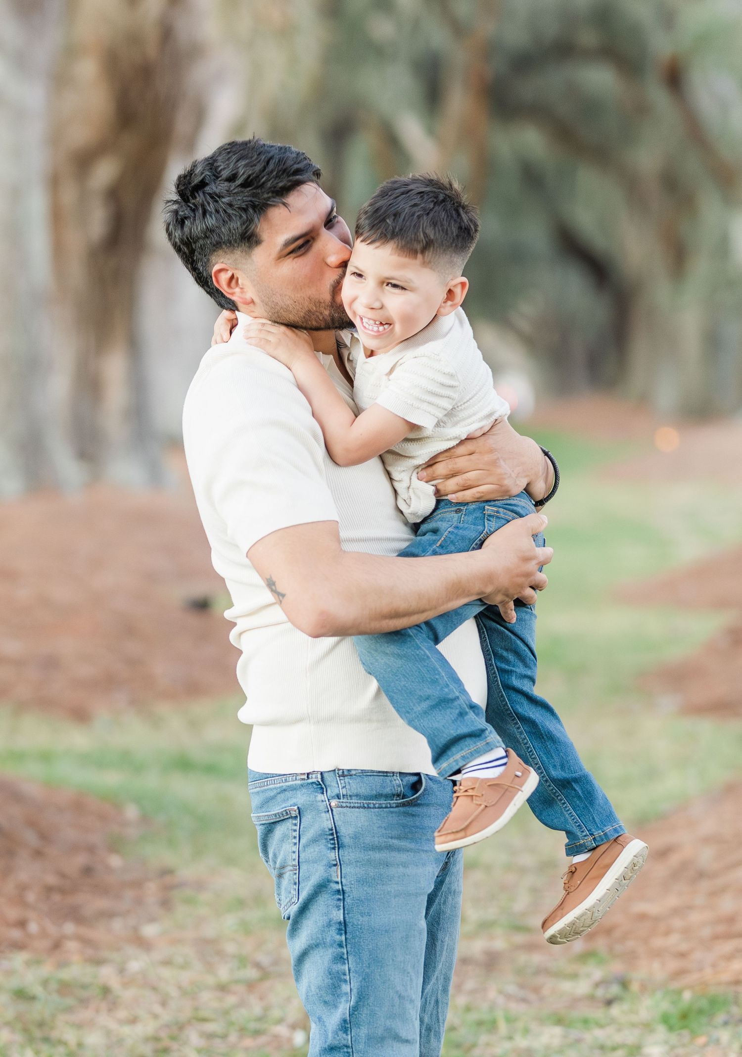 Candid moments of parent and child playing and embracing in a wooded outdoor setting.