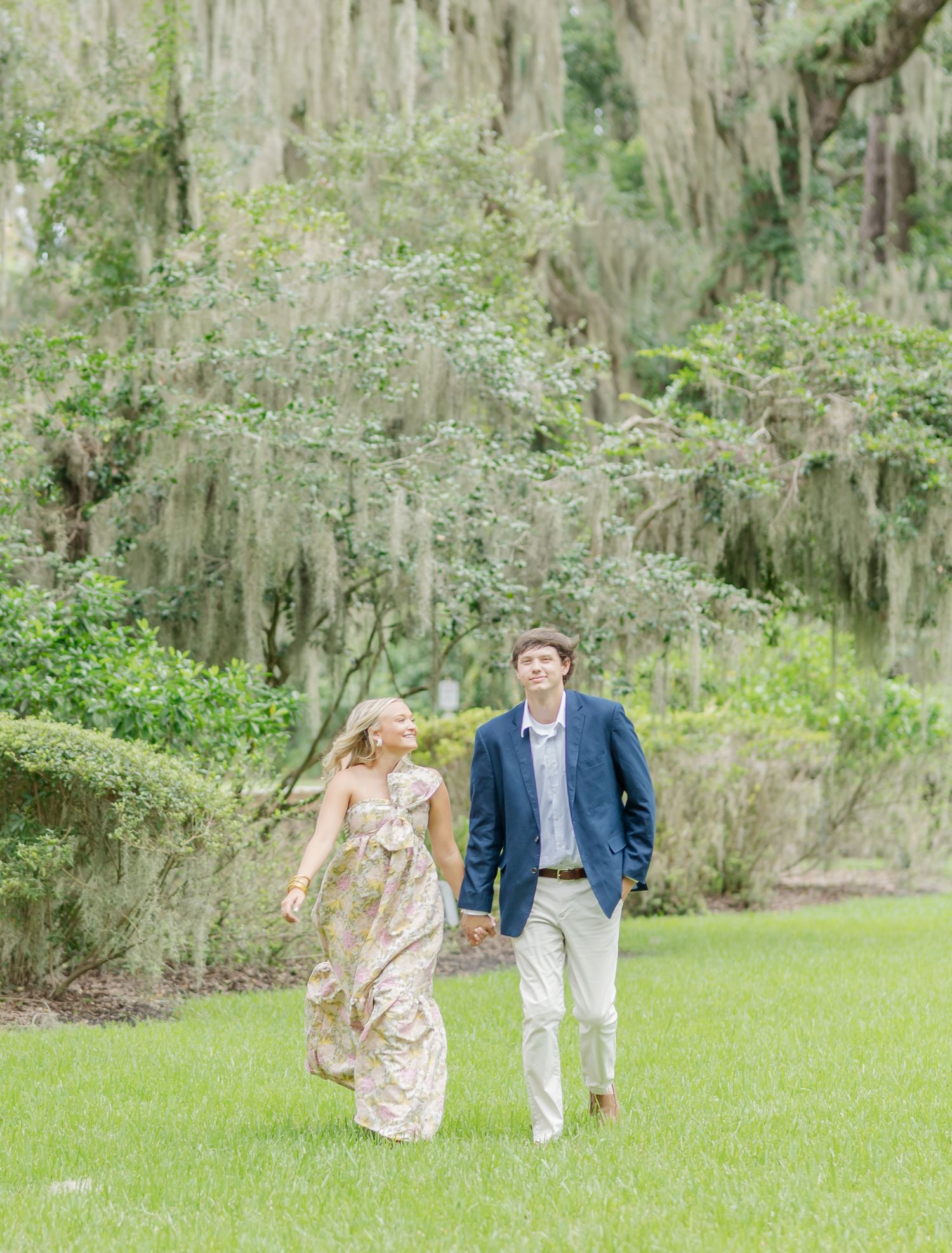 Wide garden path photo series showing couple walking and posing among Spanish moss trees.