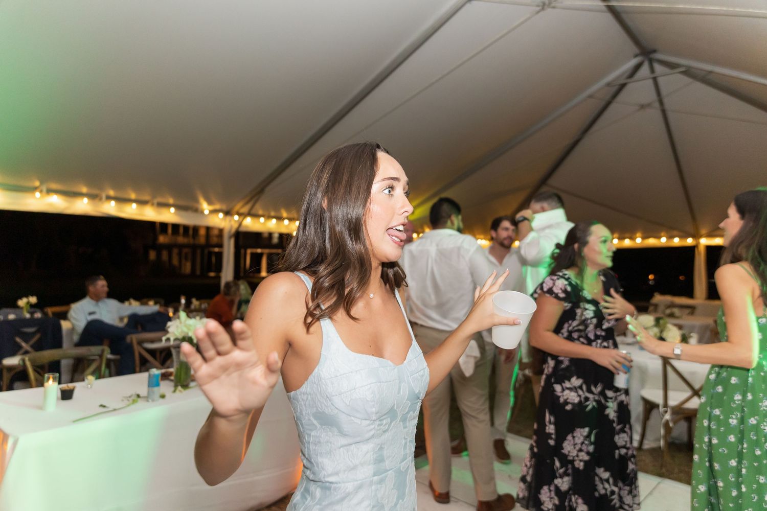 Guests enjoying themselves on a lively dance floor at an outdoor wedding reception.