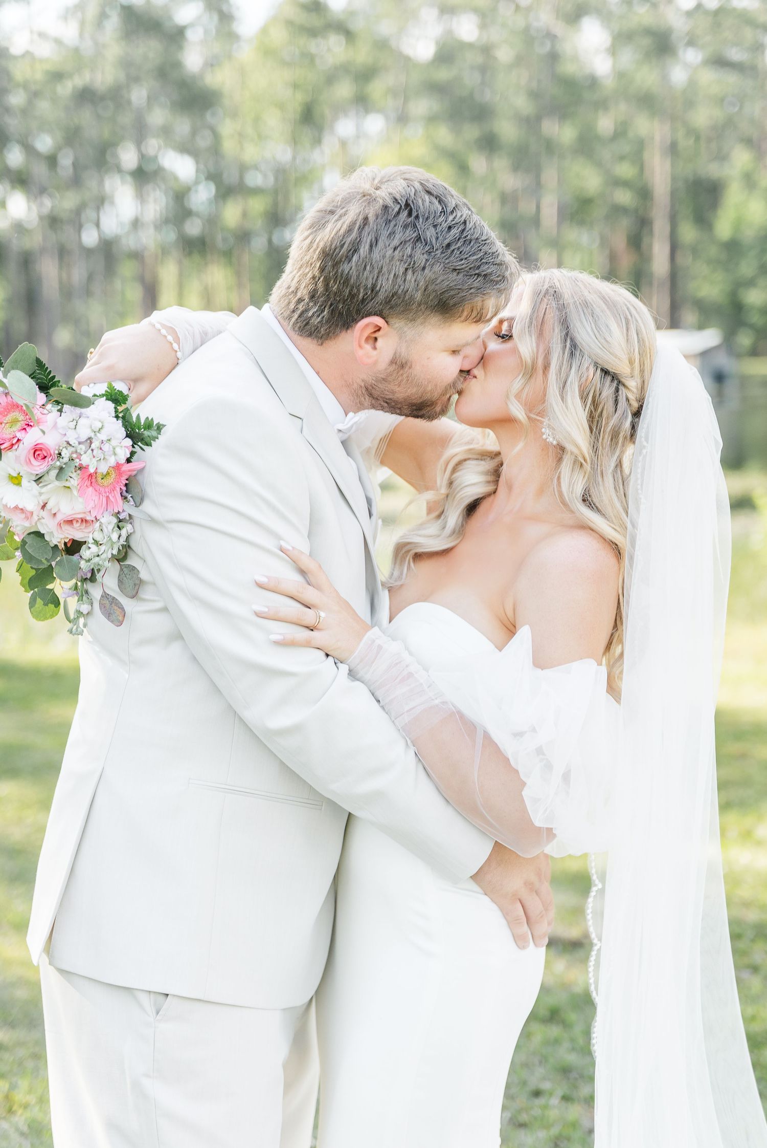 Bride and groom share a passionate moment during their lakeside wedding photoshoot.