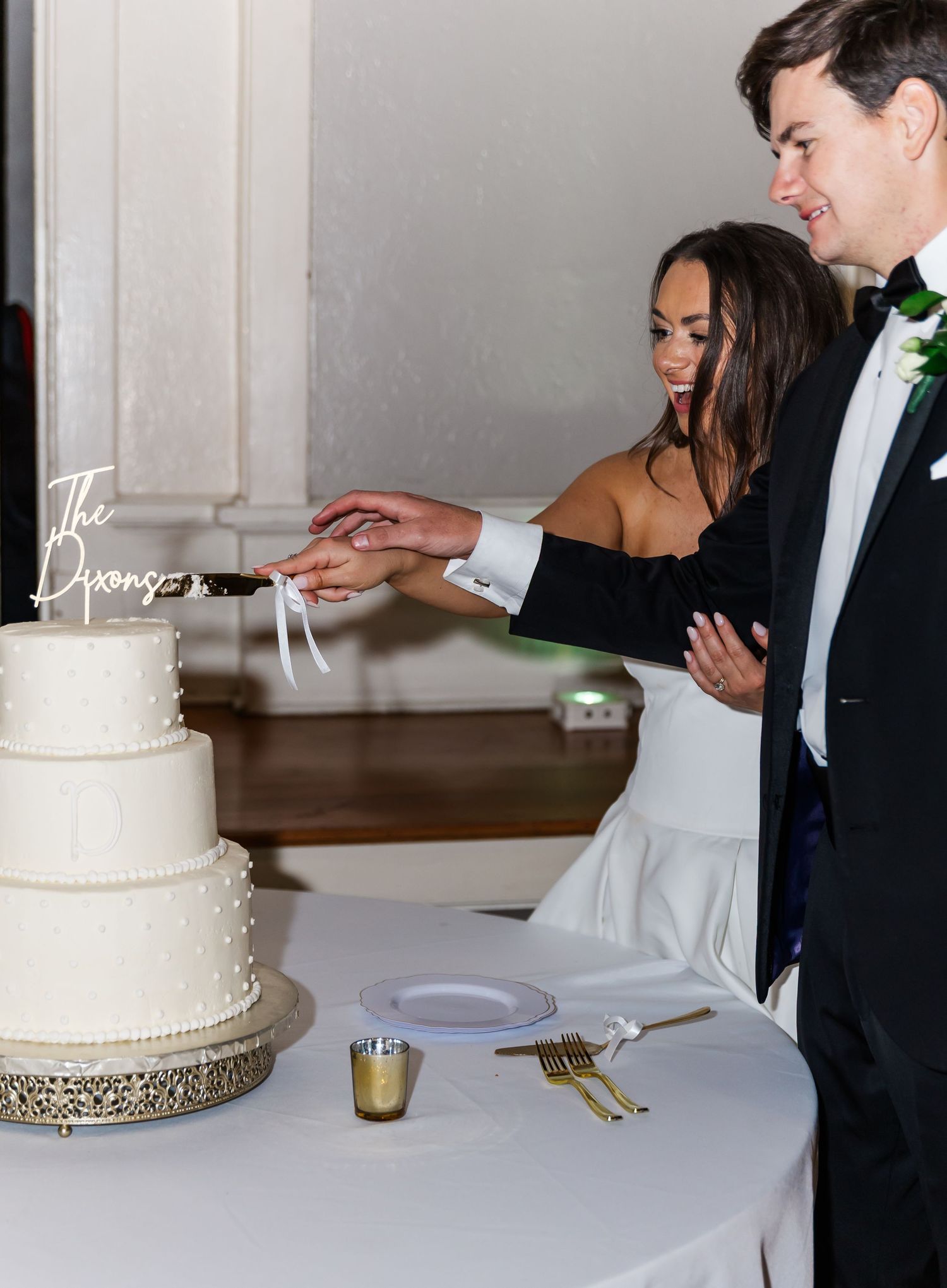 A sequence of wedding cake cutting photos showing a white tiered cake with silver trim being served at a reception.