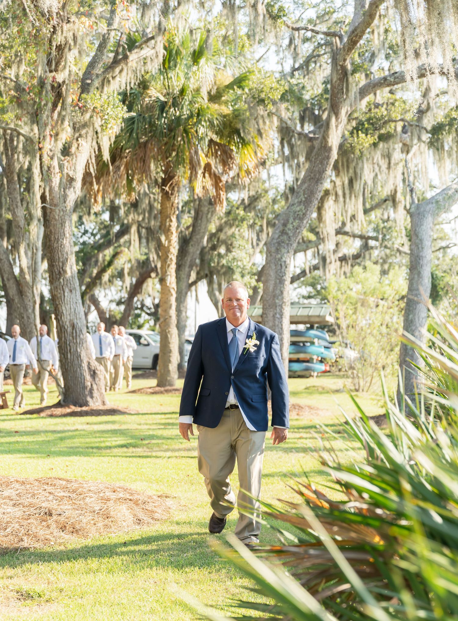 A sequence of five photos showing someone walking through a scenic path lined with Spanish moss-draped oak trees.
