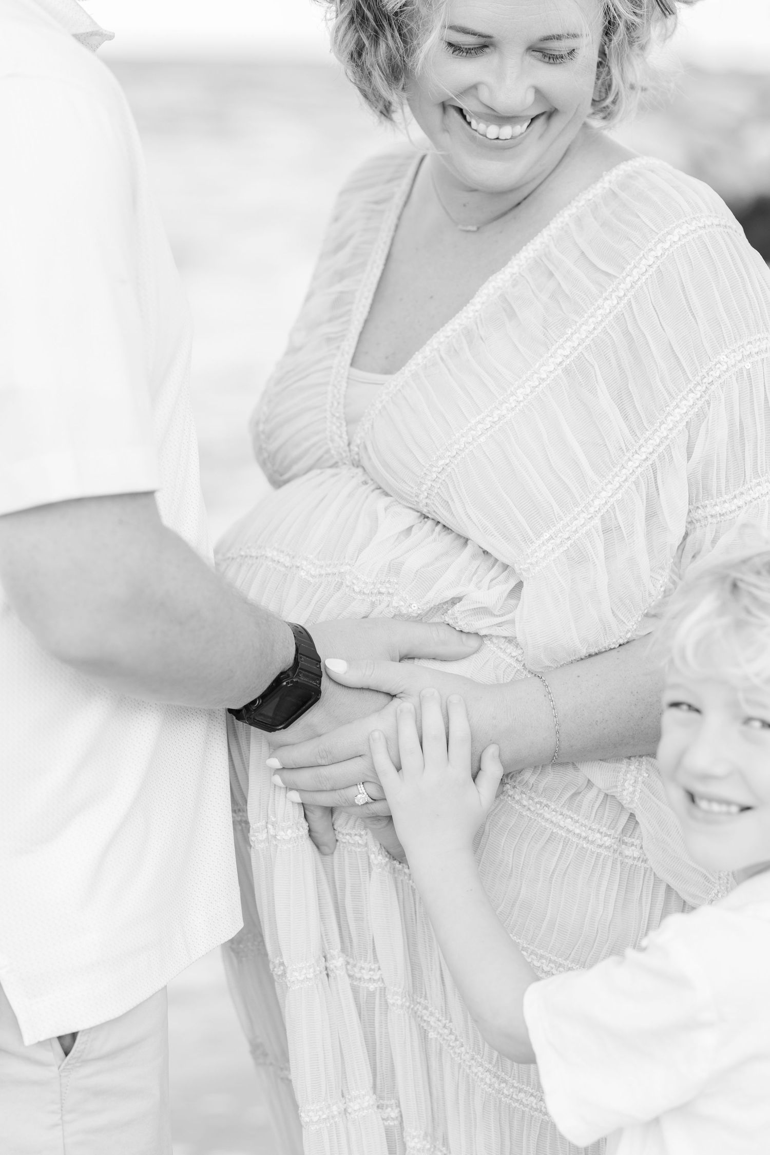 Close-up shots capture tender family moments in soft white tones.