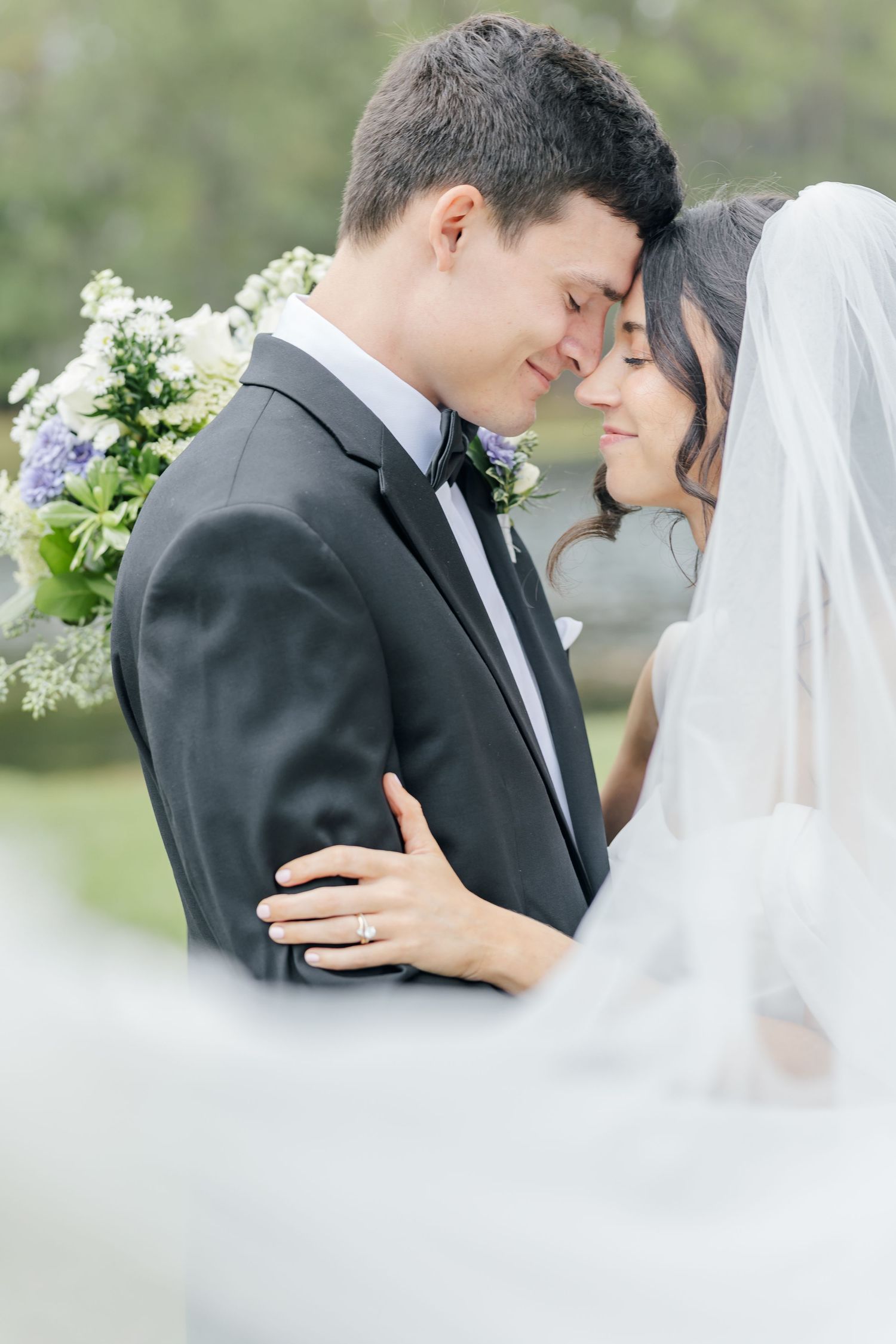 Dreamy wedding portraits show tender moments between newlyweds with soft veil details.