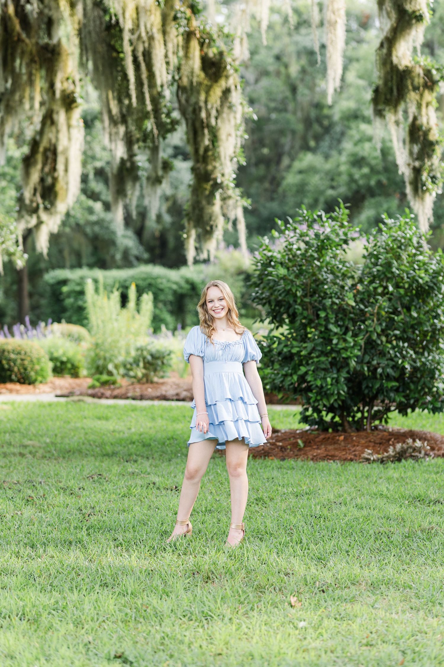 Light summer dress photoshoot in a garden with Spanish moss draped trees.