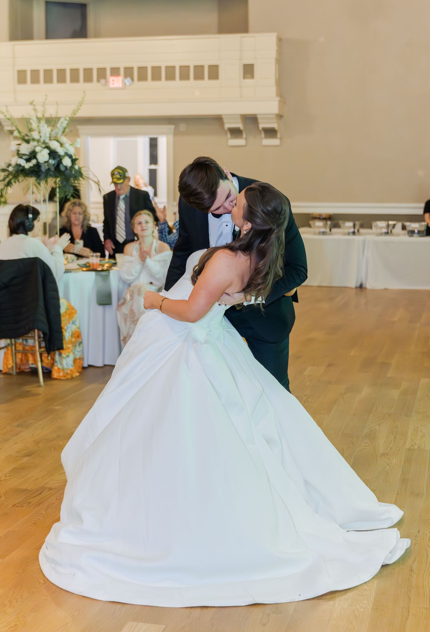 A sequence of dance moves showing a flowing white wedding dress twirling across a wooden dance floor.