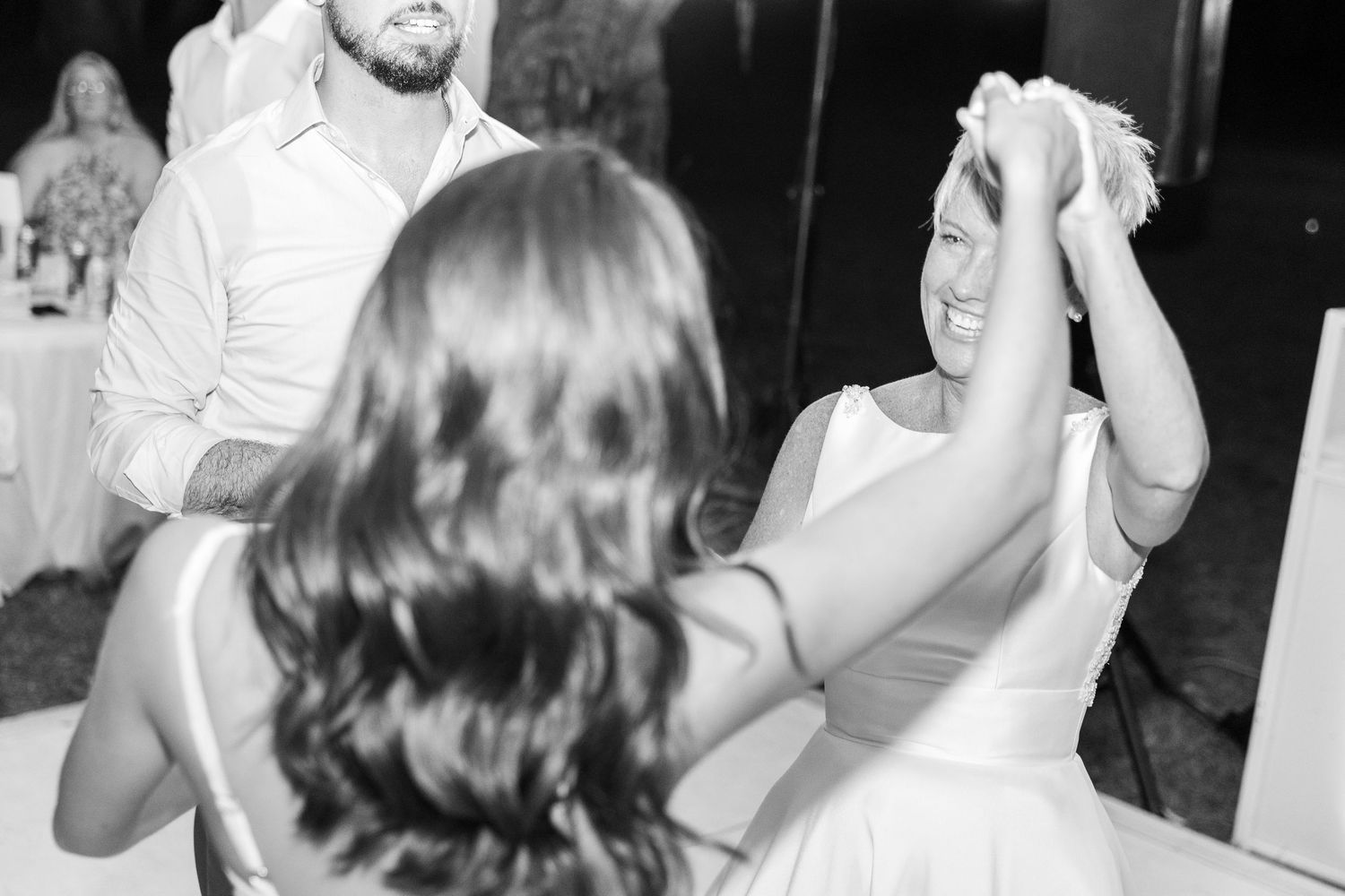 Black and white photo of couples dancing at a wedding reception.