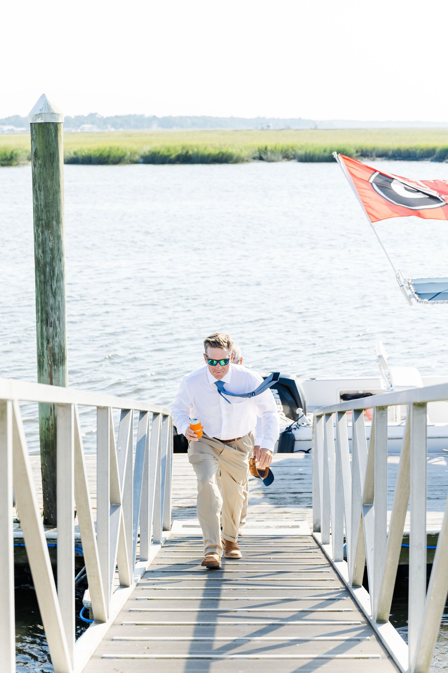 Three photos of someone planking on a white wooden dock railing overlooking a coastal marsh and water.