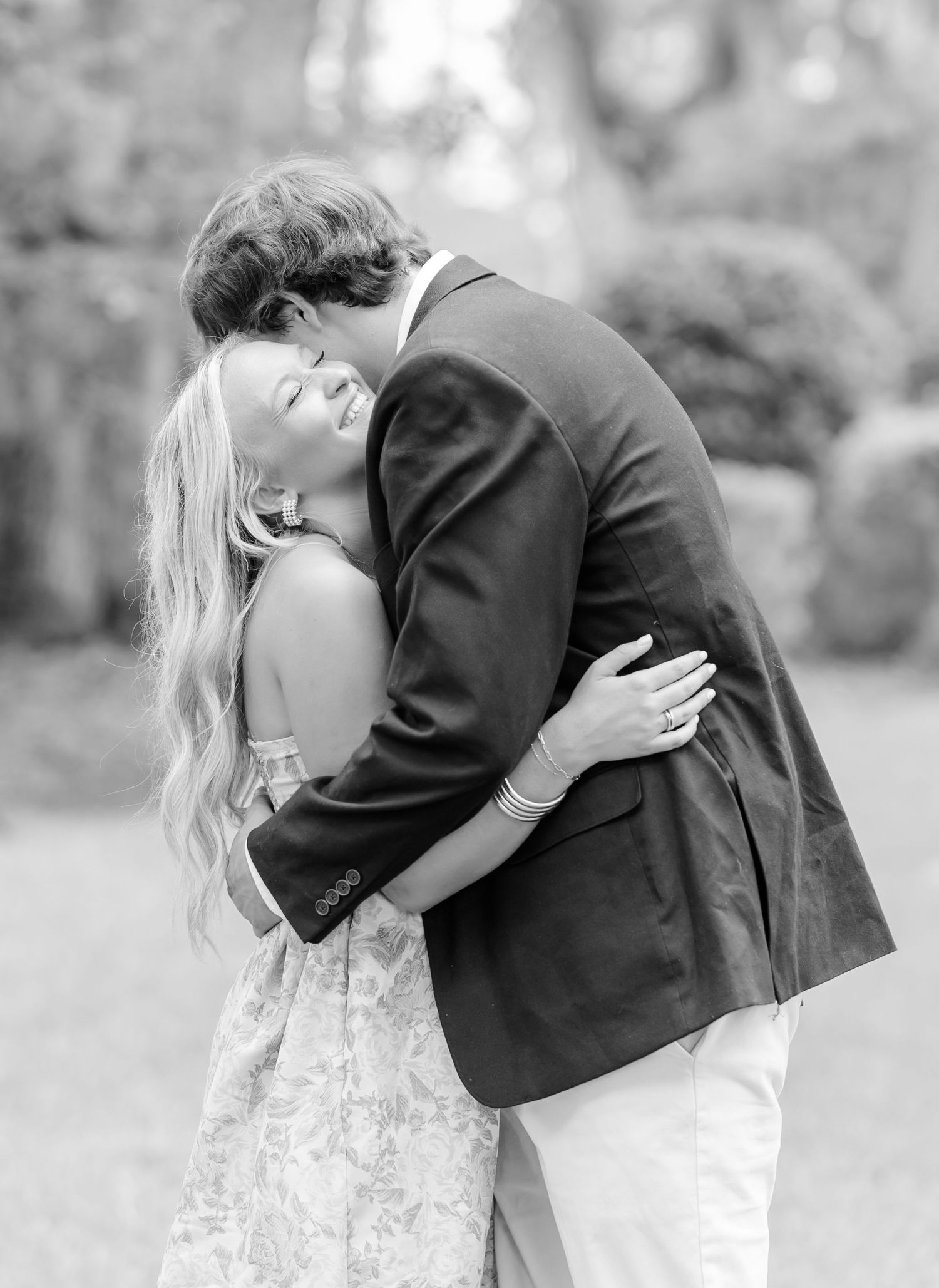 A romantic black and white photo sequence showing a couple embracing in an outdoor setting.