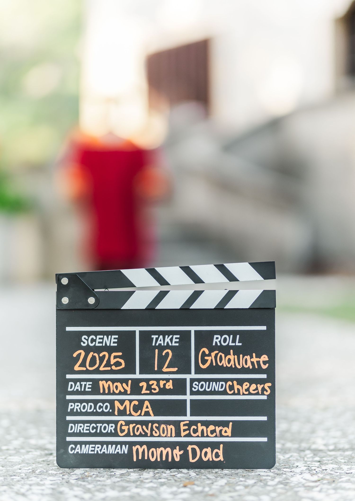 Black movie production clapperboard shown at different angles against blurred background.