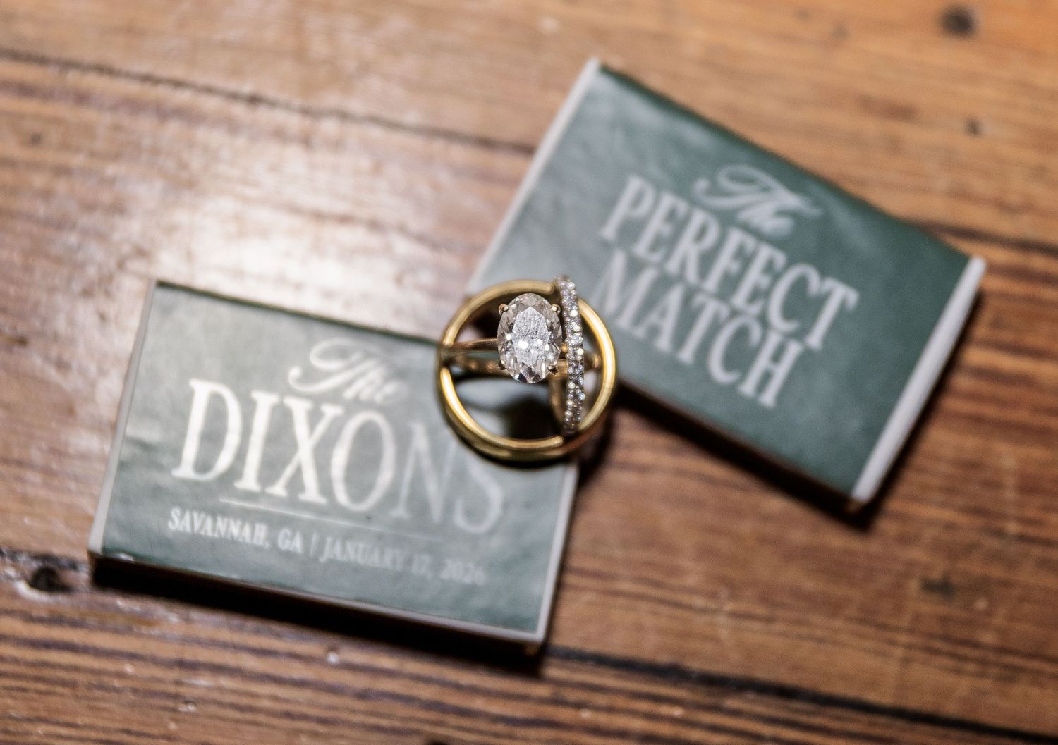 Wedding rings resting on custom matchbooks reading The Perfect Match and The Dixons, Savannah GA.
