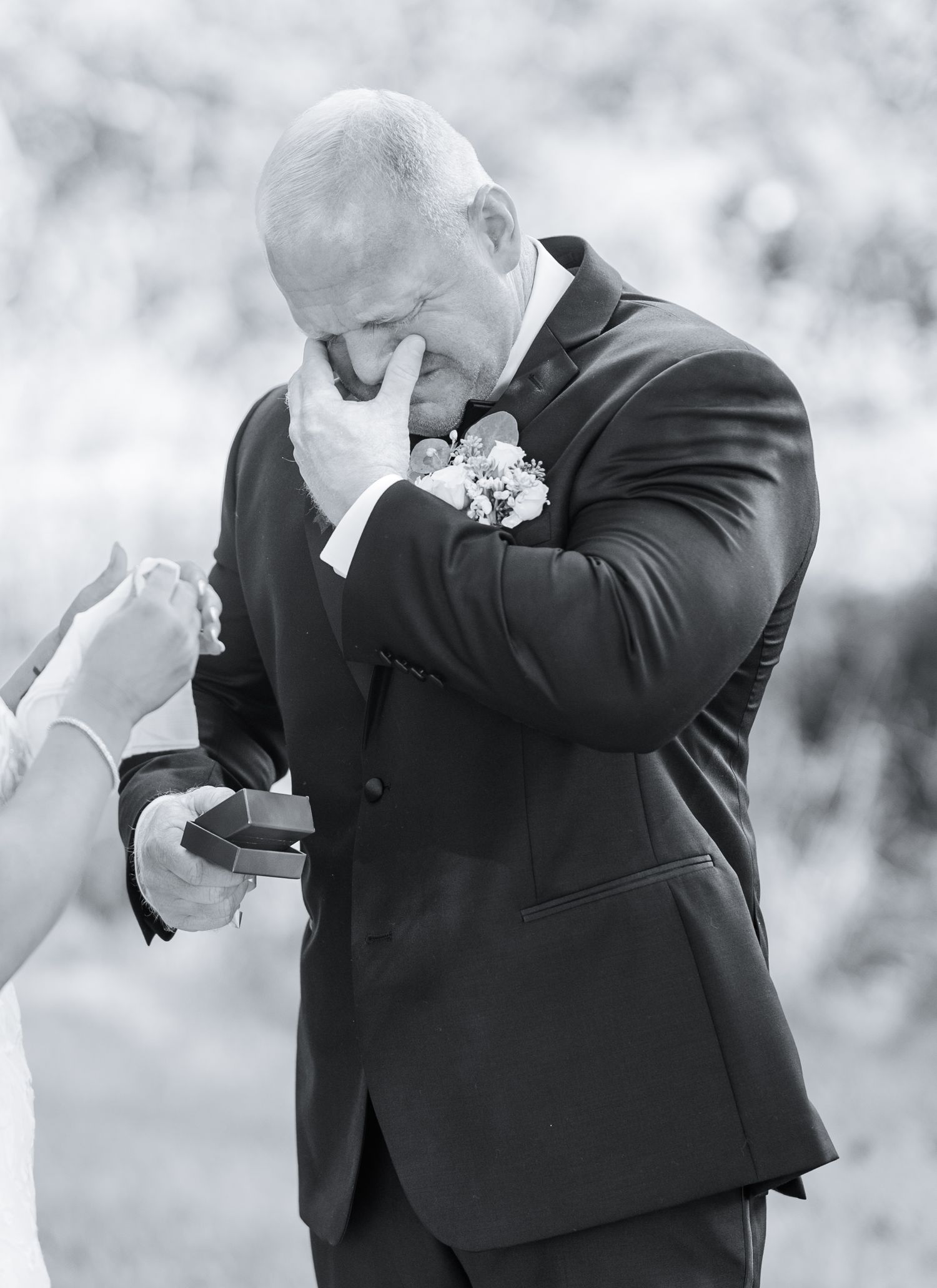 Series of black and white photos showing emotional reactions of a person in a suit at a wedding ceremony.