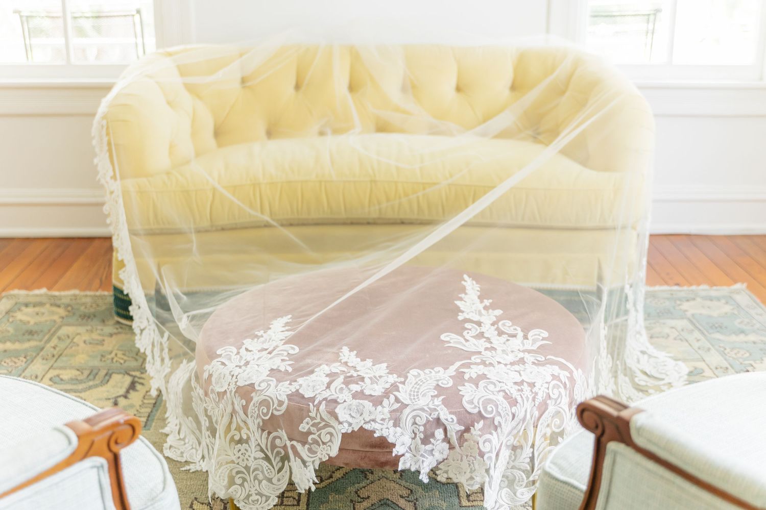 Delicate white lace trim details on soft beige fabric create an elegant vintage-inspired textile design.
