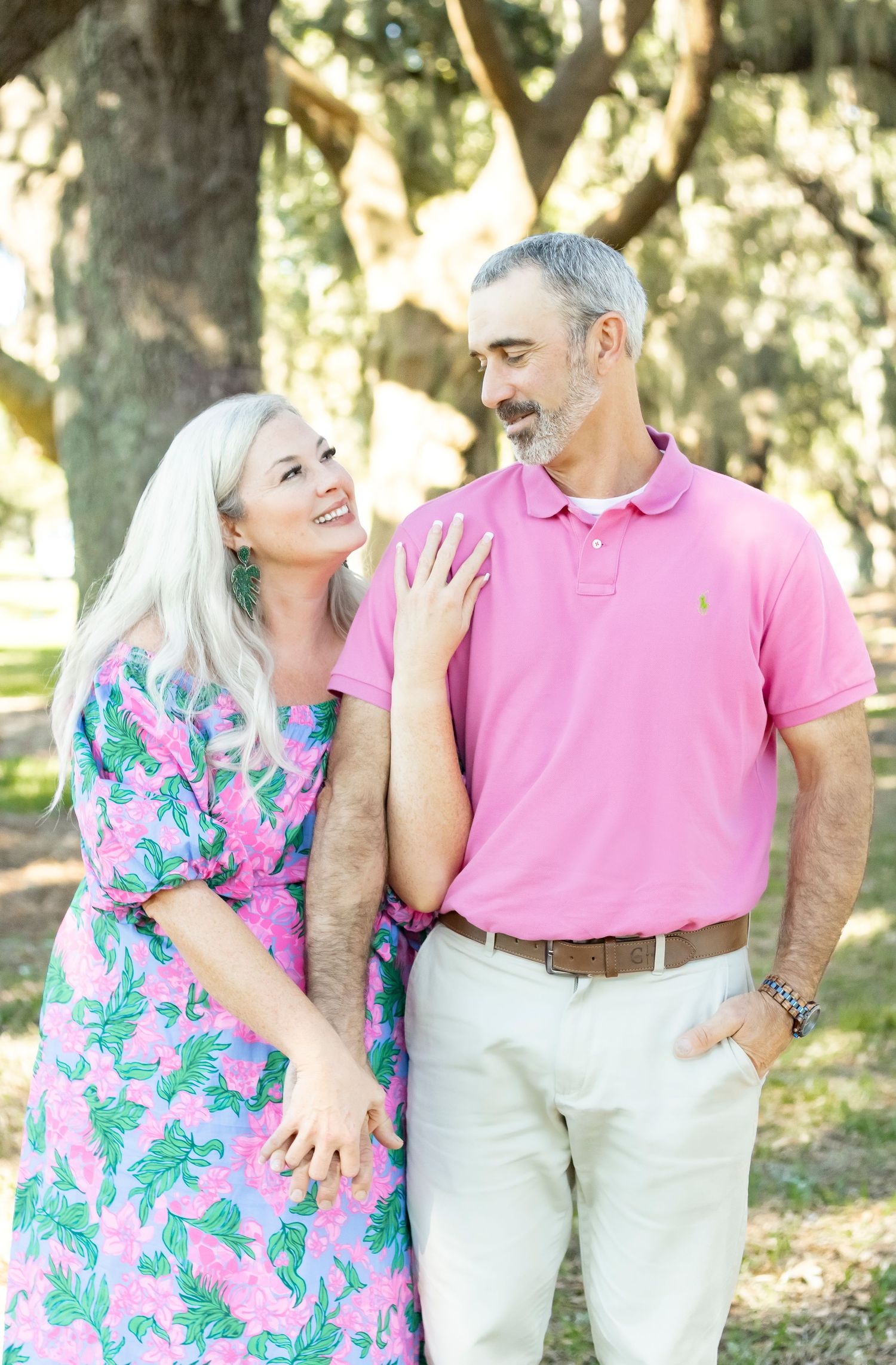 Couple shares a joyful moment together outdoors in bright summer attire.
